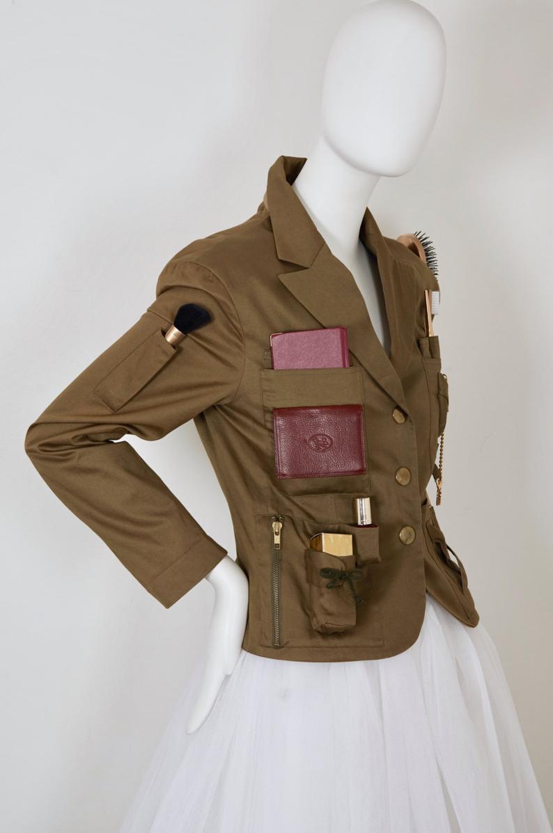 Vintage RARE MOSCHINO COUTURE Survival Jacket Military Safari Jacket

Measurements taken laid flat:
Shoulder: 18 inches (45.72 cm)
Sleeves: 23 4/8 inches (56.69 cm)
Bust: 37 inches (93.98 cm)
Waist: 33 inches (83.82 cm)
Length: 22 4/8 inches (57.15