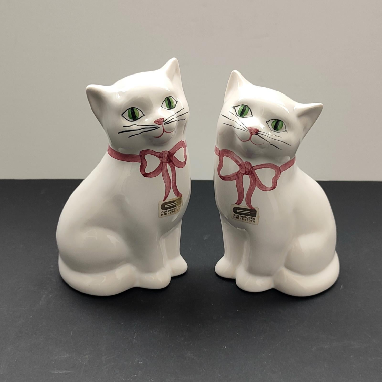 Rare Swedish porcelain cat from Guldkroken in Hjo. Vintage. White hand painted facial features & pink bows. Made in Sweden in the 70s. Original makers label.
Excellent condition.
Dimensions: 
Height: 18 cm [7”], Width: 11 cm [4,3”], Depth: 8 cm