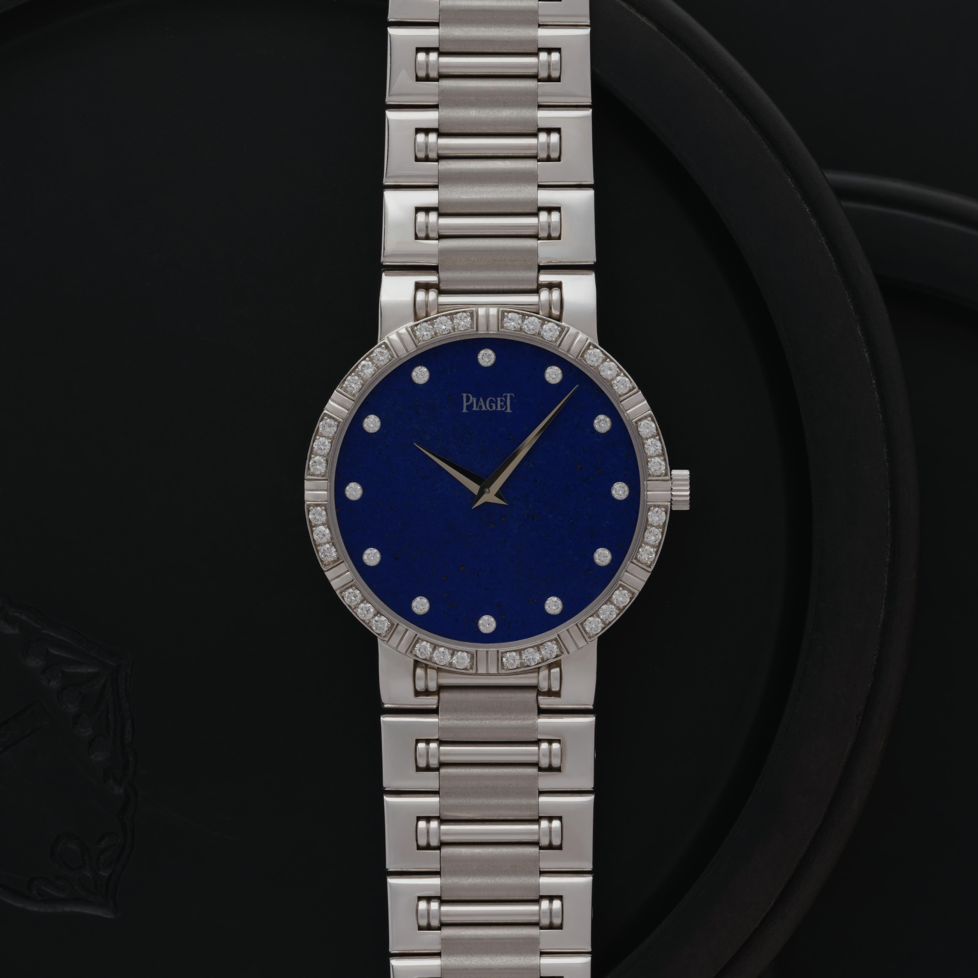 Maker: Piaget
Model: Dancer 94024 K81 
Year: 1986
Material: 18k White Gold, Lapis, Diamonds
Dial: Lapis and Diamond
Case Measurement: 32mm
Movement: Manual Wind
Condition: Like new
Weight: 85 Grams
Size: Adjustable, Fits Up to 6.3