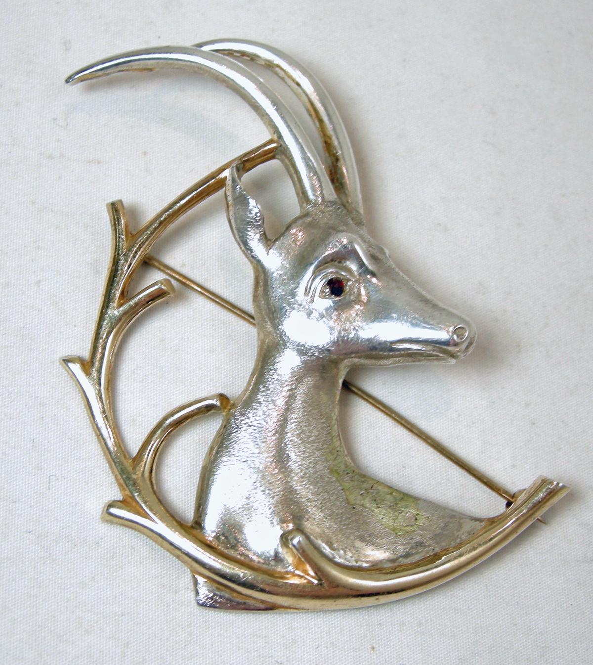 This rare vintage Ibex brooch is a superb work of sterling art.  The Ibex is a member of the European mountain goat family. The workmanship catches your eye immediately. It has red crystal eyes. In excellent condition, this brooch measures 2-7/8” x