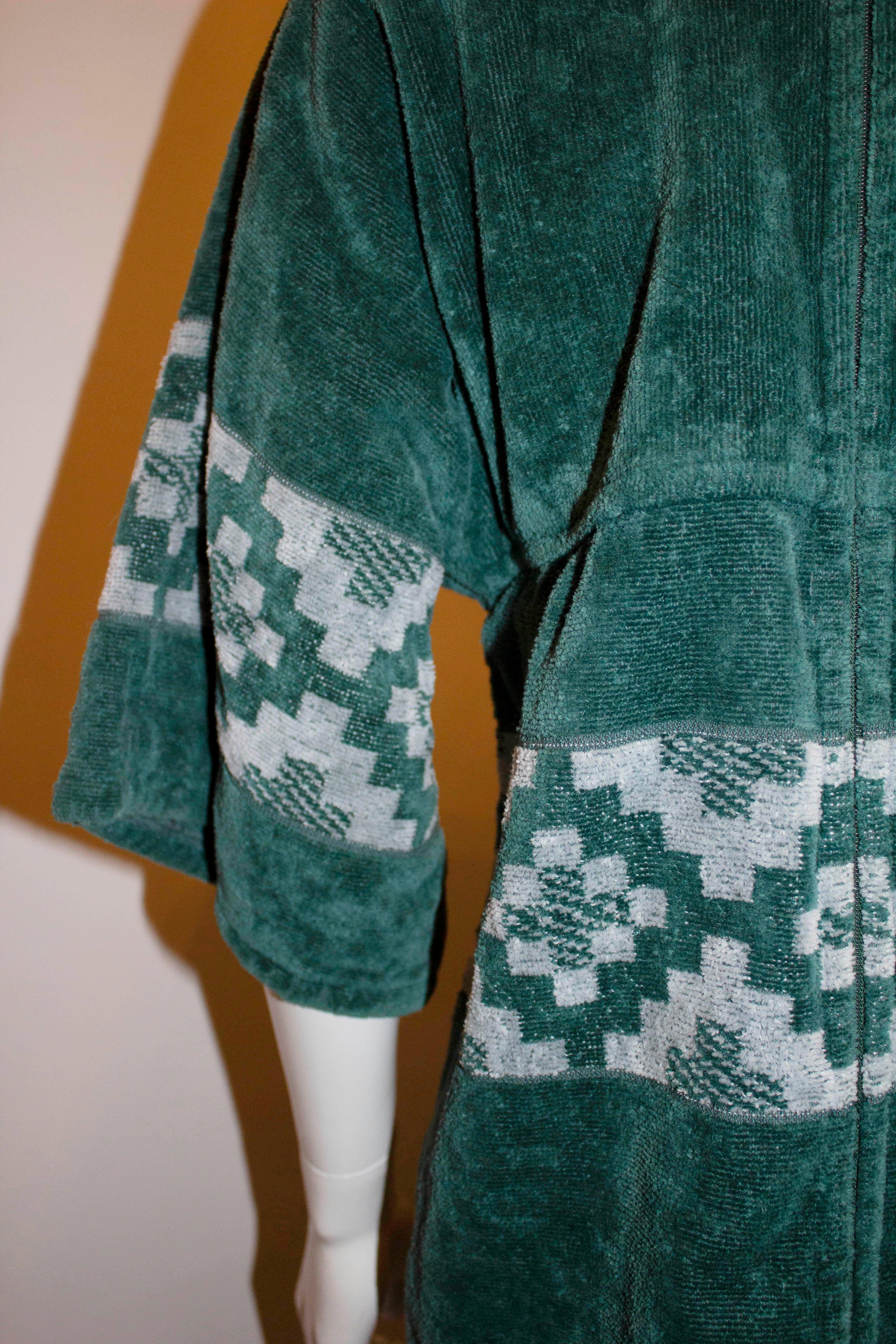A rare vintage, Yves saint Laurent towelling beach /pool robe. In a sea green the robe has a back zip opening, pockets on either side and a 20'' slit on either side. 
Measurements: Bust 37'', length 55''