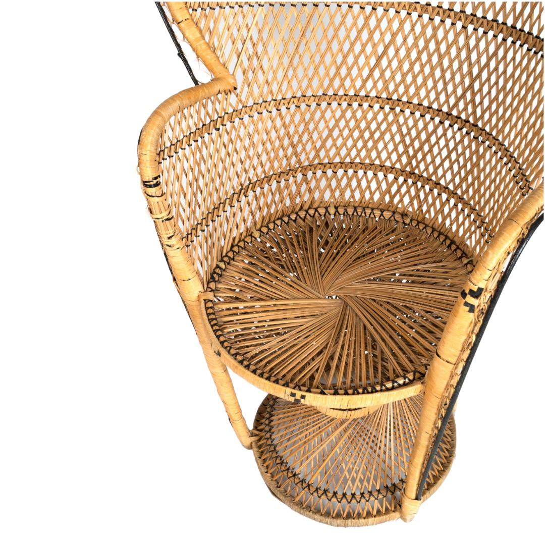An exquisite 1960s Italian rattan peacock chair, featuring a woven fan-shaped back and curved solid arms. This sculptural and iconic silhouette captures the elegance of mid-century design. Wear is consistent with age and use. See photos for