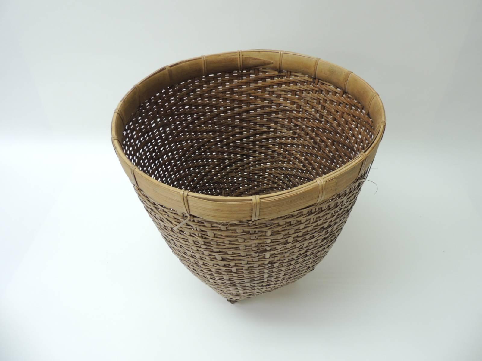 Vintage rattan and bamboo waste basket or planter.
Tight woven body with flat bamboo feet and around the top of the basket.
Size: 12 x 14 H.