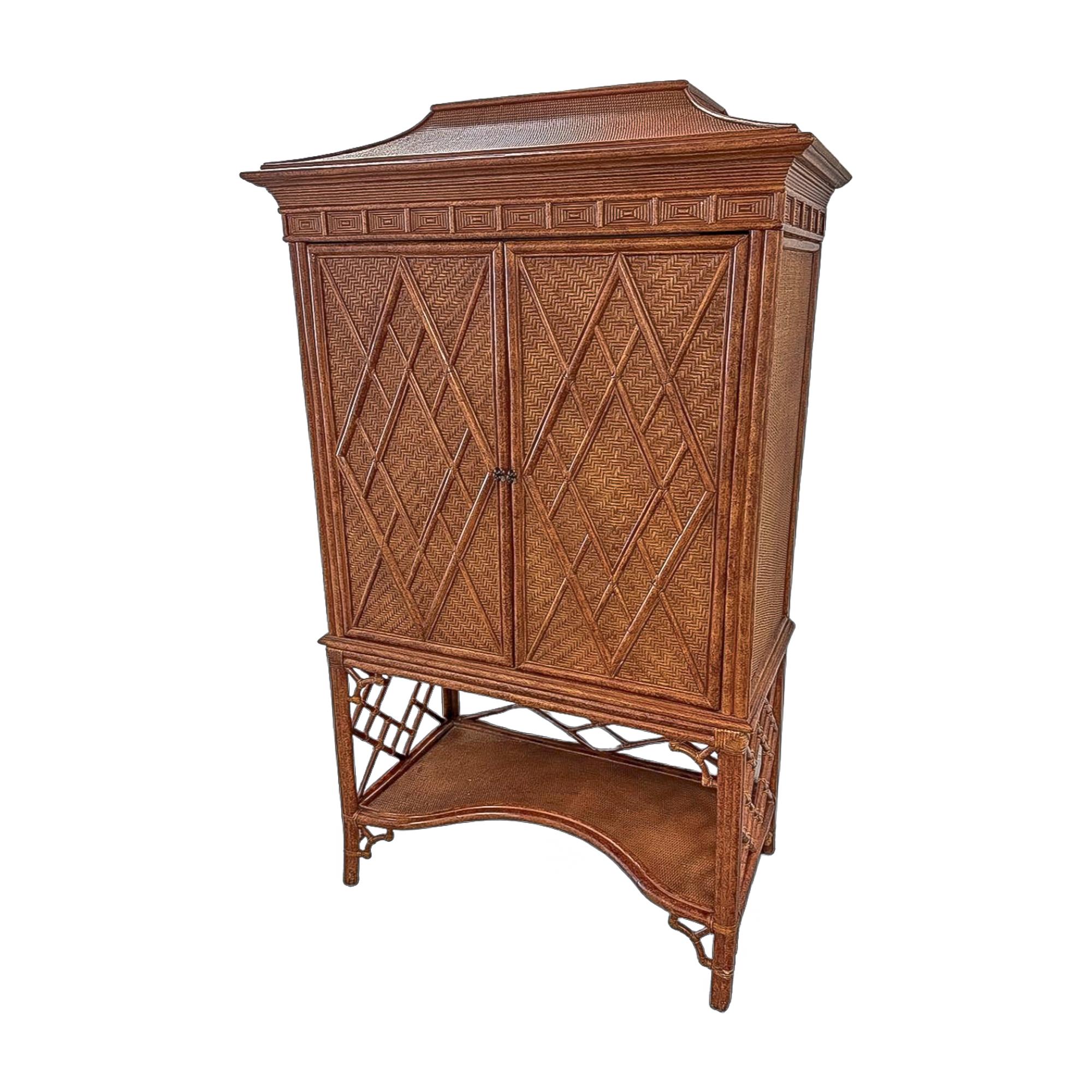 This vintage rattan and cane cabinet offers both presence and versatility, blending Chinoiserie Revival style with British Colonial influence. The double doors feature an intricate diamond-weave cane pattern, framed in wood and rattan for depth and