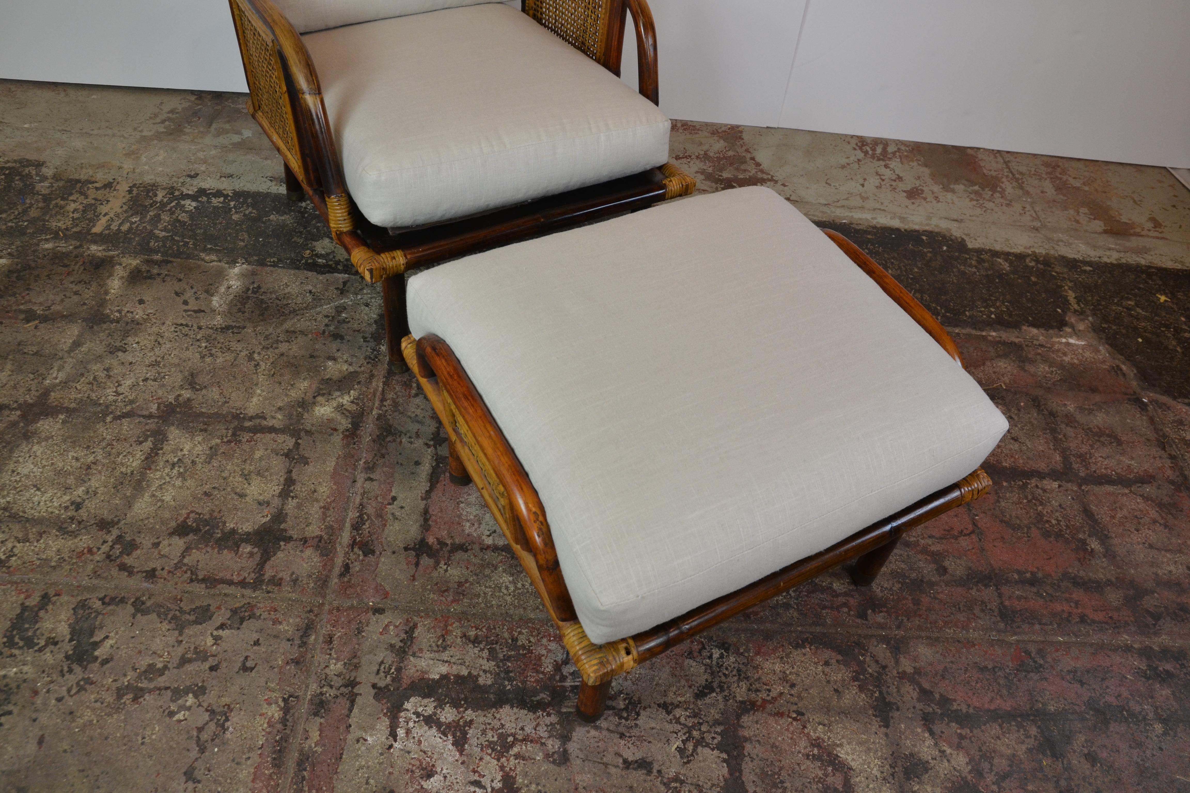 A beautiful modern rattan and cane lounge chair and ottoman from a limited series by Ficks Reed Company, circa 1950. Expertly crafted hardwood and rattan construction with cane panel detail. A fabulous design that is extremely comfortable. Newly