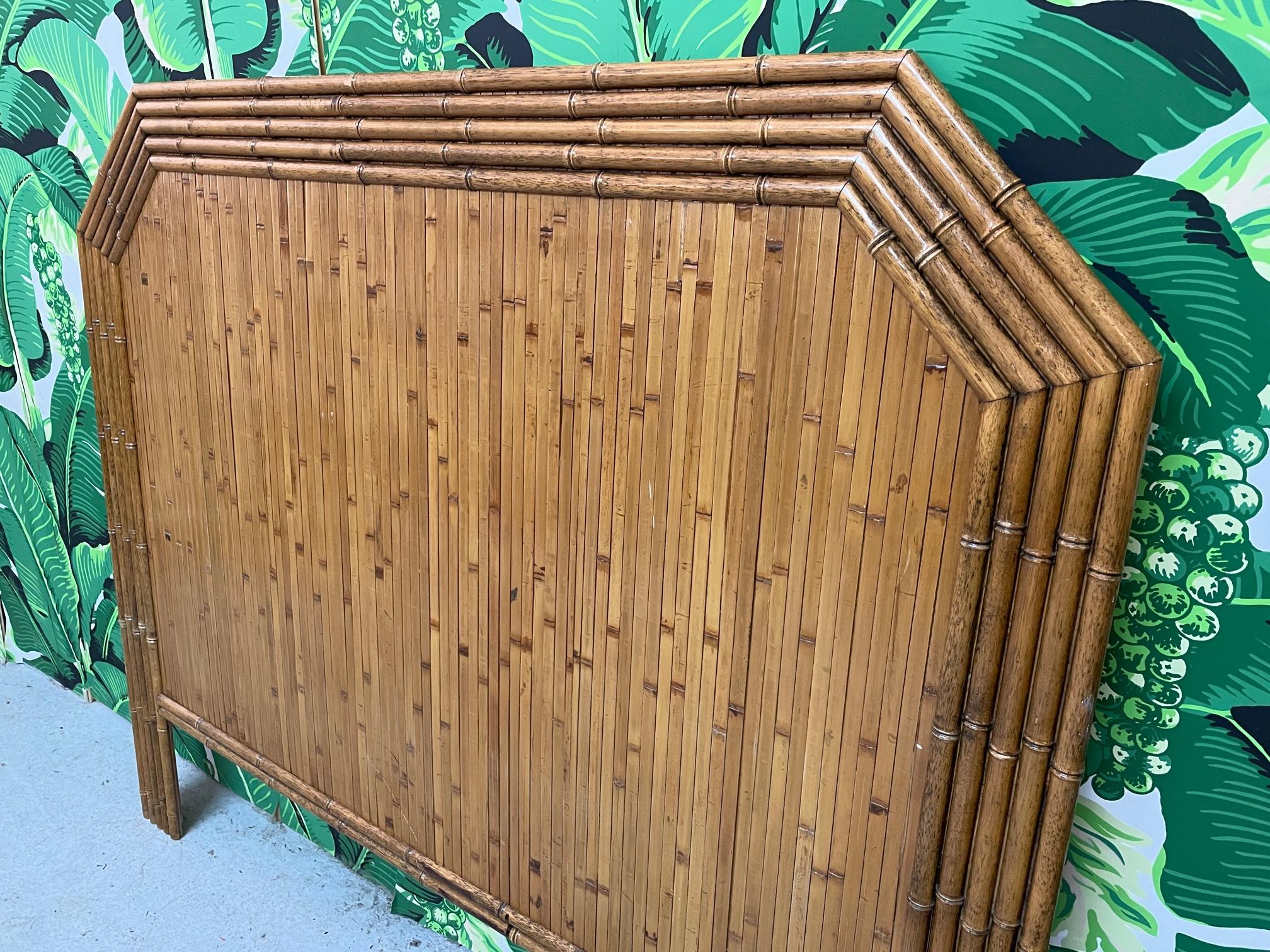 Vintage headboard features a full veneer of split reed rattan and faux bamboo detailing. Bed size is full. Very good condition with minor imperfections consistent with age.