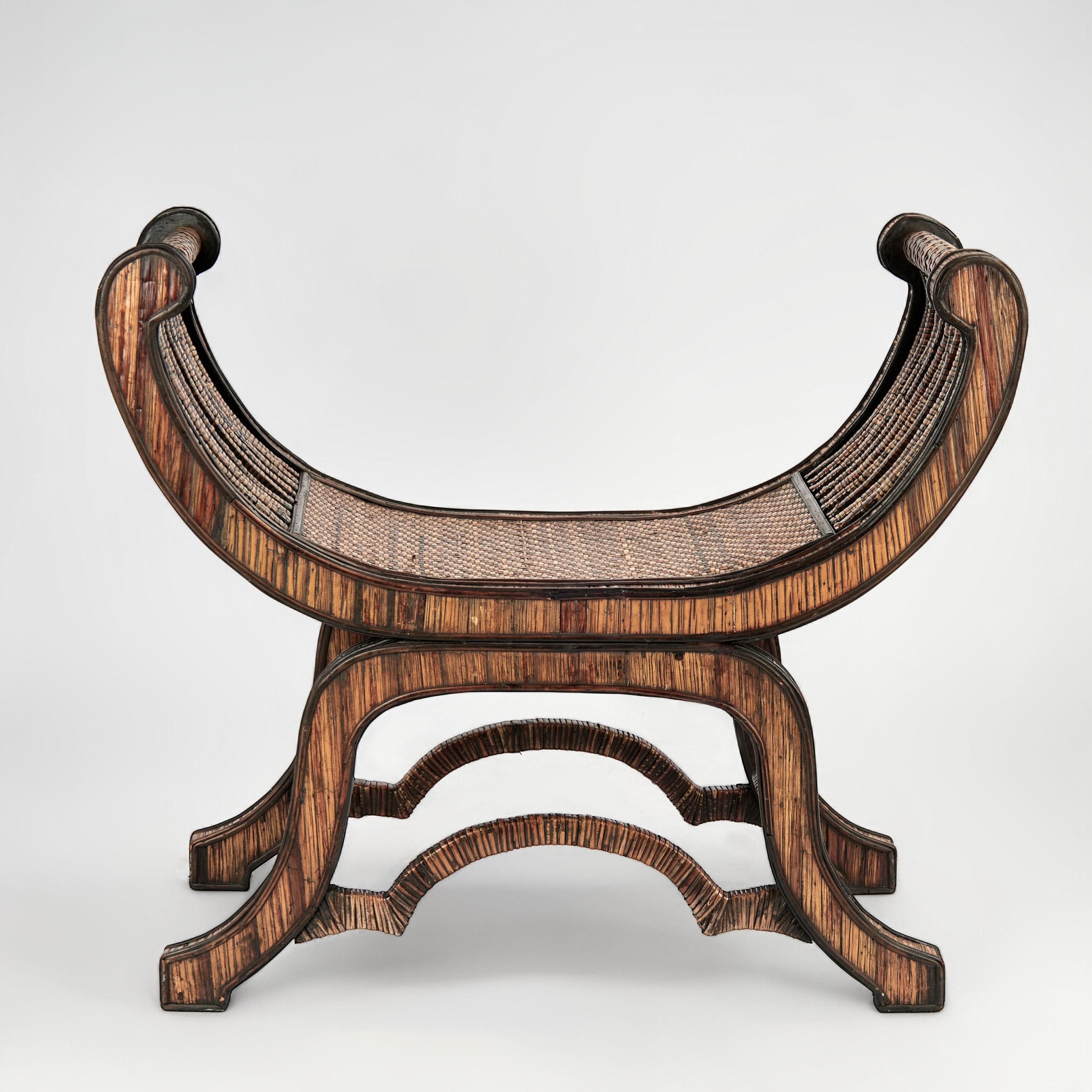 Inspired mid century bench handcrafted in an ancient Egyptian rolled arm form made modern with woven rattan and grasscloth highlighted with bent rattan on a base with cabriole legs and stylized stretchers.