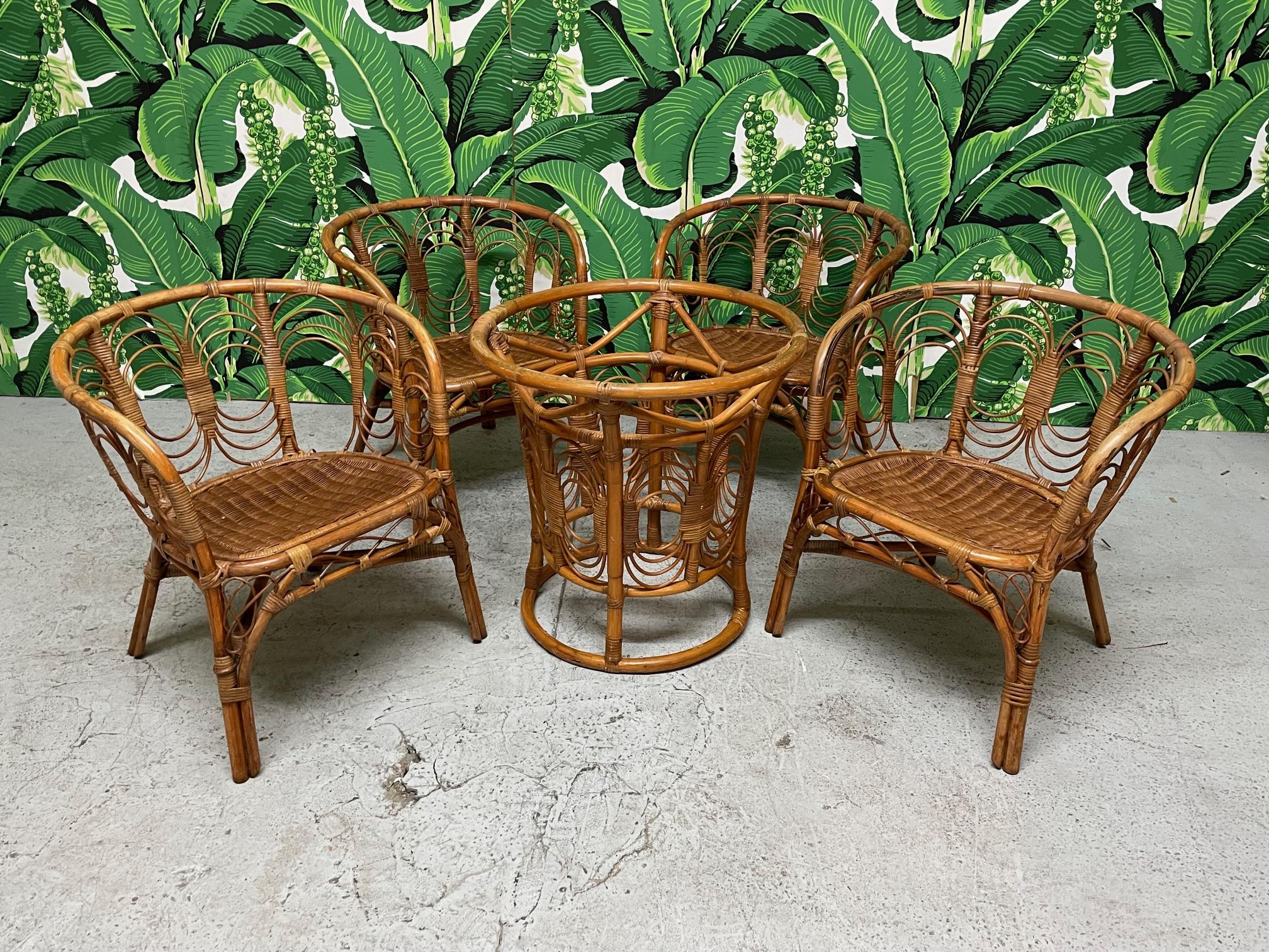 Vintage rattan dining chairs features glass top round table and 4 chairs with wicker seats. Great as a game table or breakfast set. Pedestal base with 42