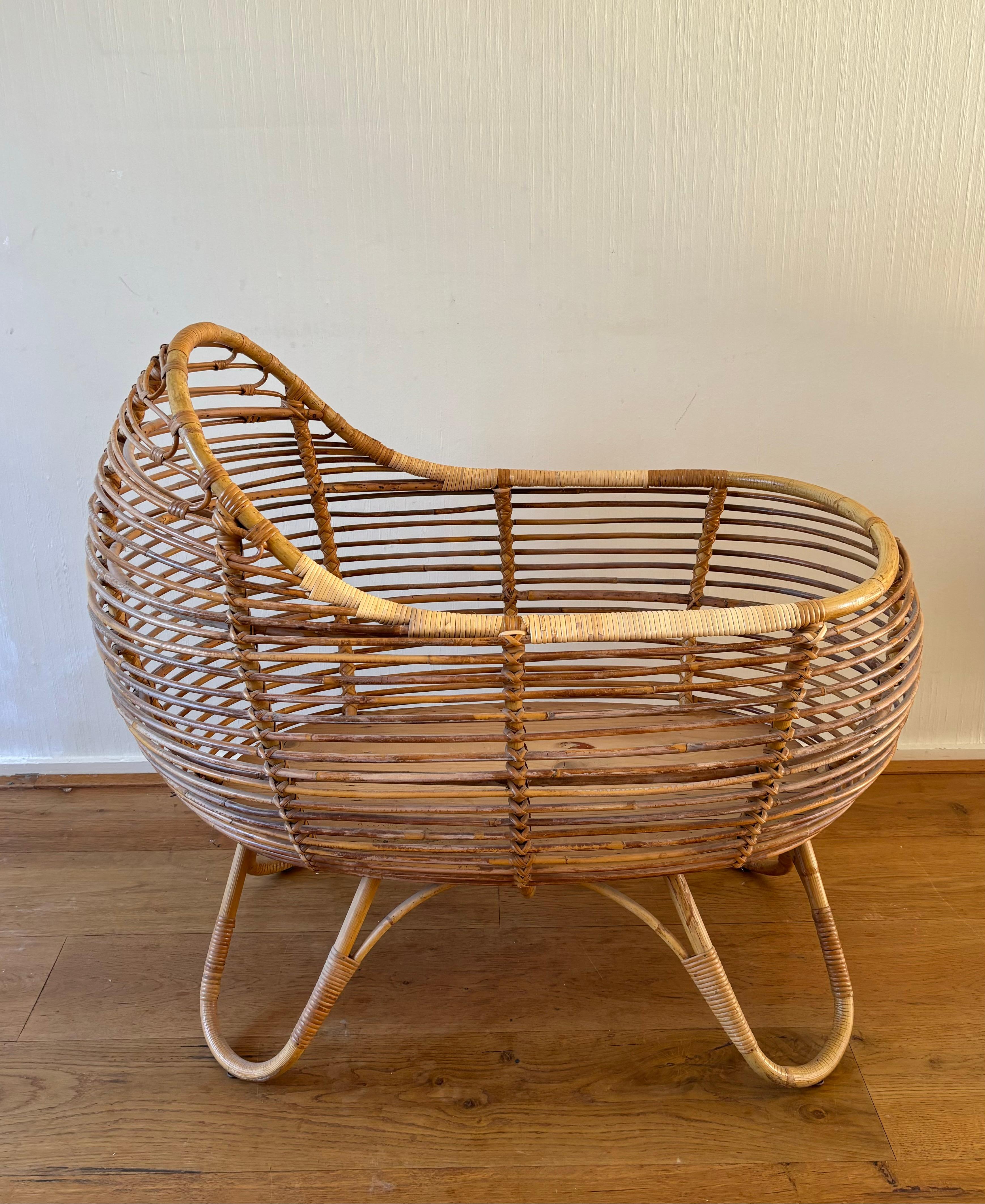 Breathtaking Mid-Century Rattan Baby Bed, most likely manufactured by the former Dutch factory Rohé, Ca. the 1960s. Former owners took off both handles of the crib,  we had it professionally look like they were never there in the first place.