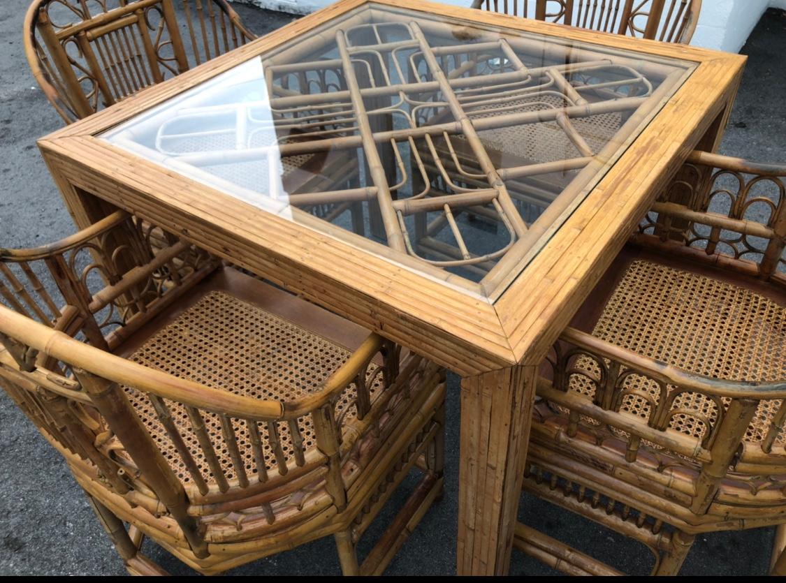 Lovely vintage 5-piece game or dining table with 4 dining chairs in the style of Brighton Pavillion. Glass top.
Table measures 29 tall x 36 square.