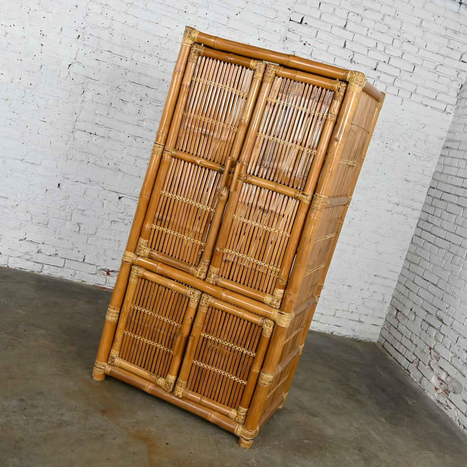 Gorgeous vintage organic modern or coastal style rattan and bamboo armoire or wardrobe style upright cabinet. Beautiful condition: however, it is vintage and not new so will have signs of use although minimal. Please see photos. Circa Late 20th