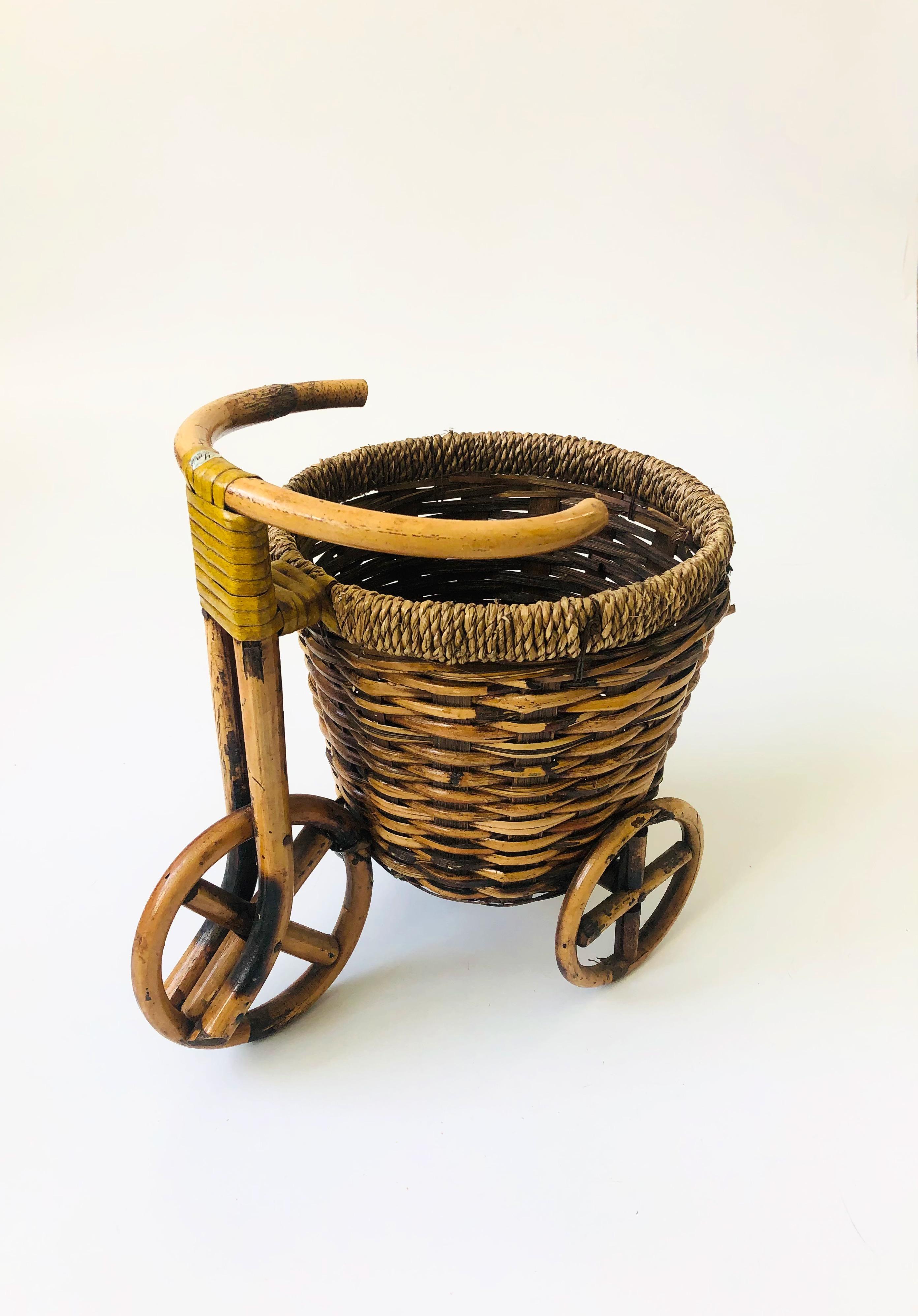 An adorable vintage plant basket bicycle. Sweet rattan detailing to the wheels a nice built in basket perfect for keeping a medium sized plant.
 