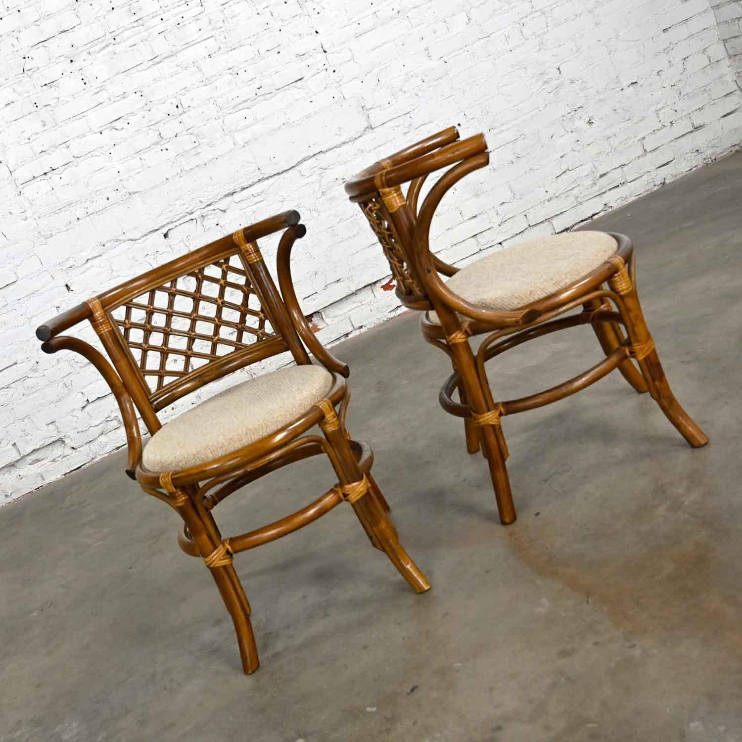 Handsome pair of vintage rattan & cane side chairs with oatmeal or off-white nubby tweed fabric seat cushions and woven diamond pattern yoke seat backs. Beautiful condition, keeping in mind that these are vintage and not new so will have signs of