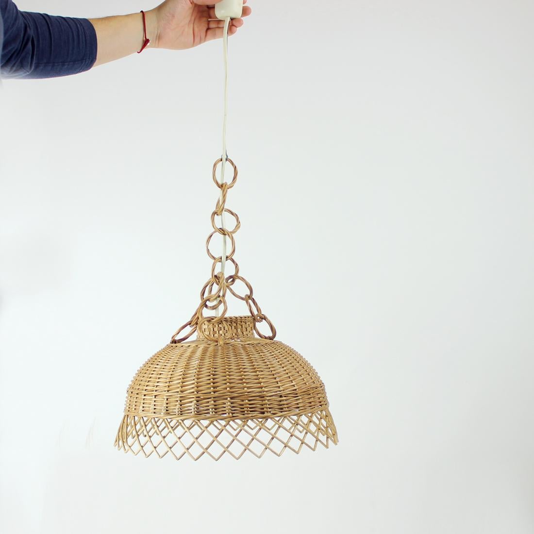 Beautiful vintage ceiling light produced in mid-century era of design. Produced in a fully rattan finish and shield. The rattan shows some aging but there are no damages or broken parts. Gives out beautiful light effect form the shield. The light