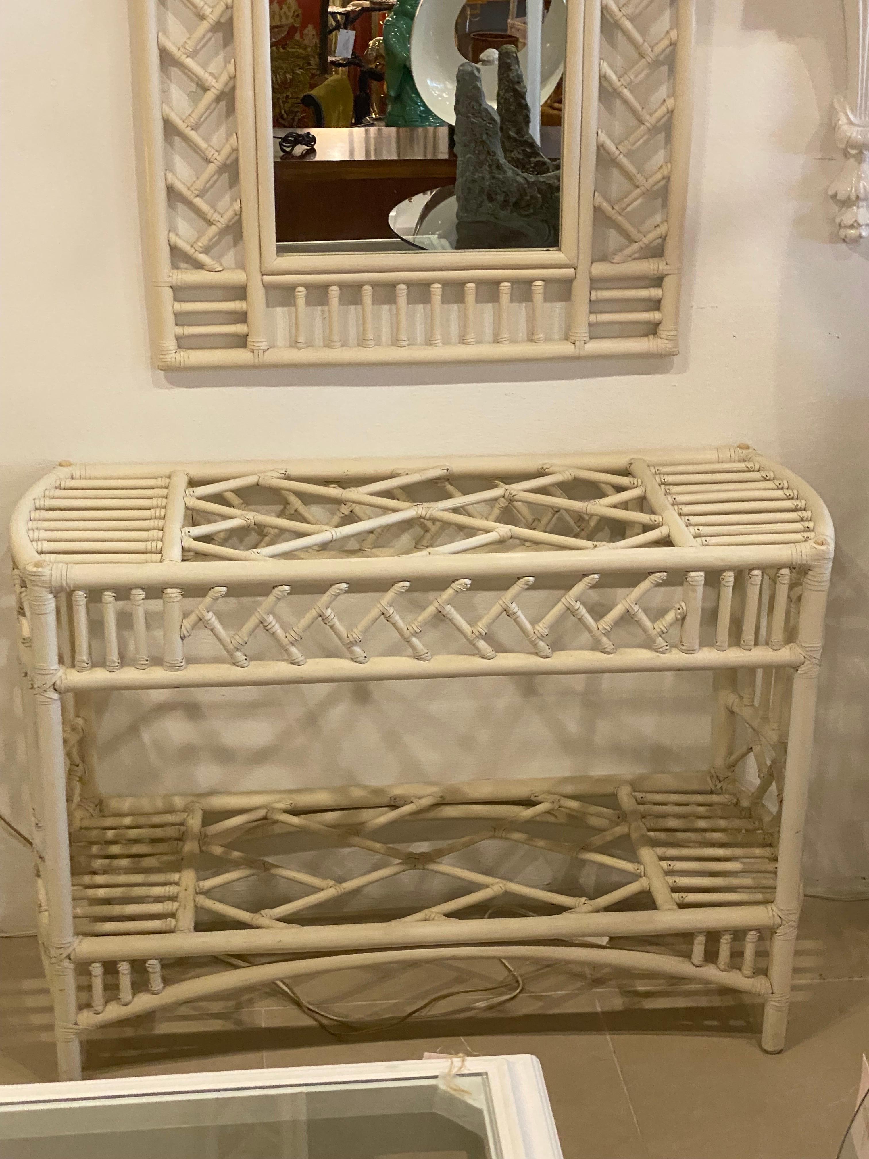 Vintage rattan Chinese chippendale Ficks Reed console table with glass top. Original cream paint and glass top may have minor imperfections. Second shelf could also take a piece off glass. Mirror pictured is listed separately. Dimension of base only