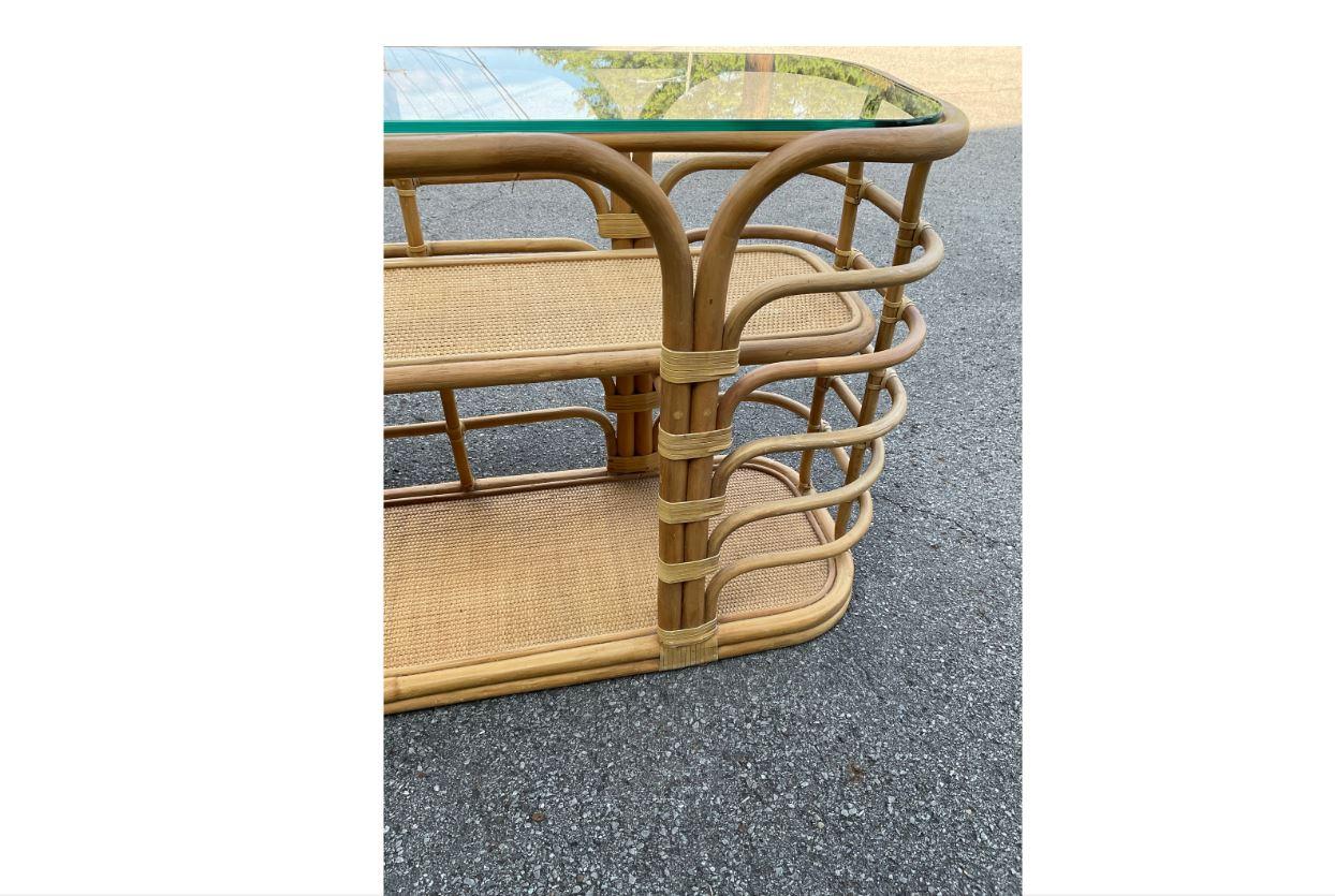 This vintage rattan console table is in perfect condition. With its beautiful rounded edges of warped bamboo and its beautiful light colored wood this piece would be an excellent addition to any Boho chic or nautical home.