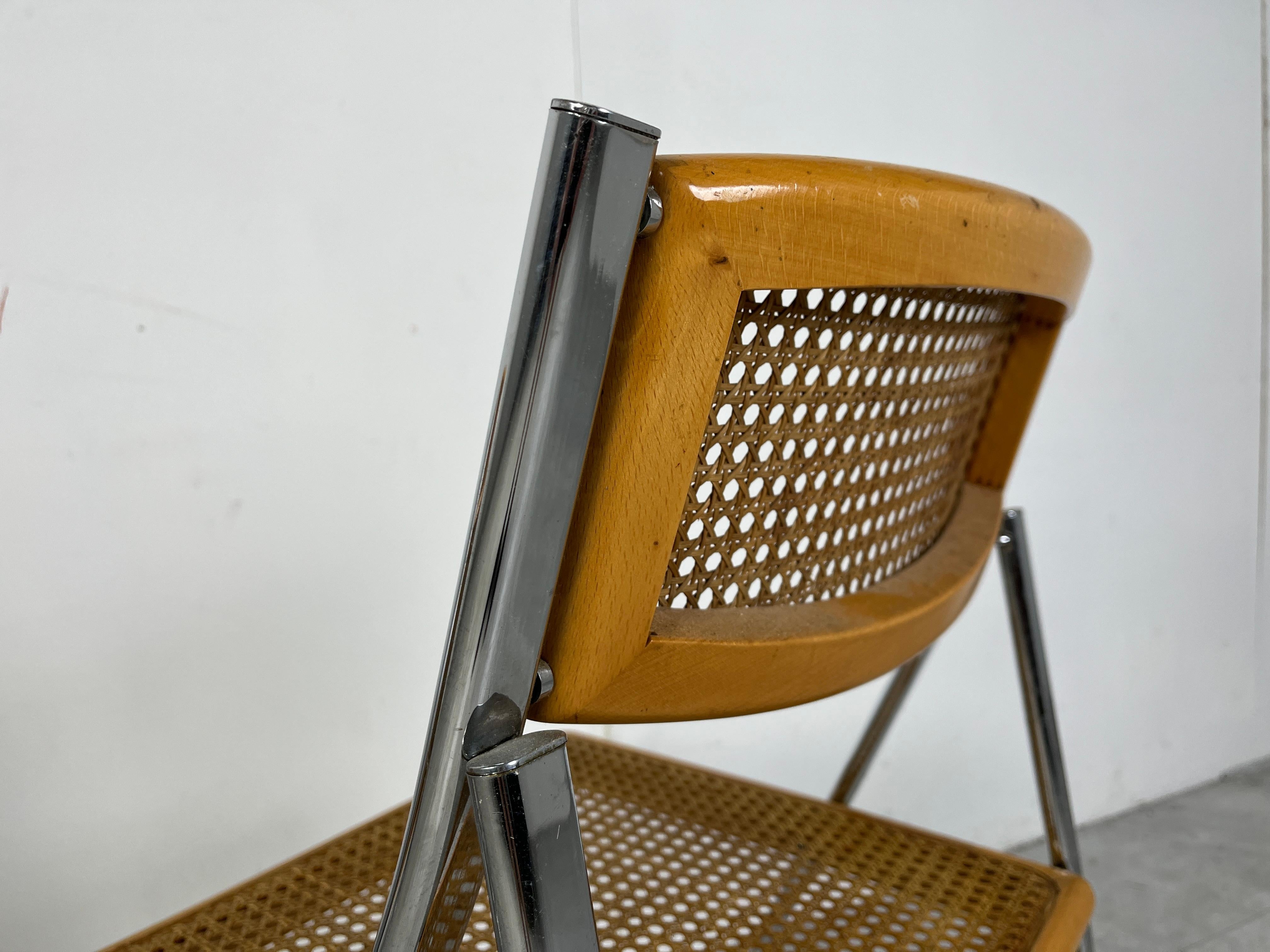 Set of 4 vintage italian foldable chairs with a chrome and beech wooden frame and rattan backrests/seats.

Timeless and practical design.

Good condition.

1970s - Italy

Dimensions: 
Height: 84cm/33.07