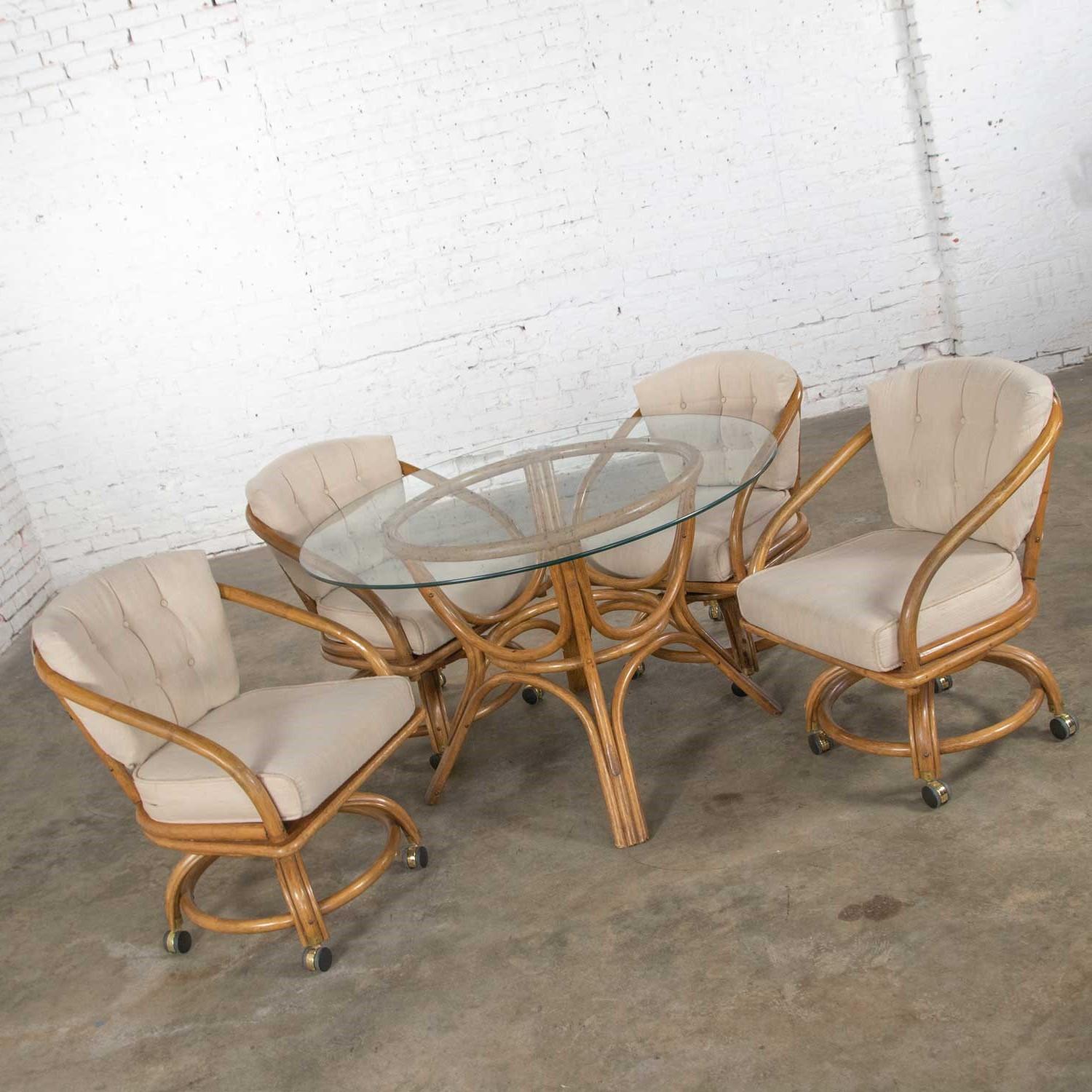 round wicker table with glass top and 4 chairs