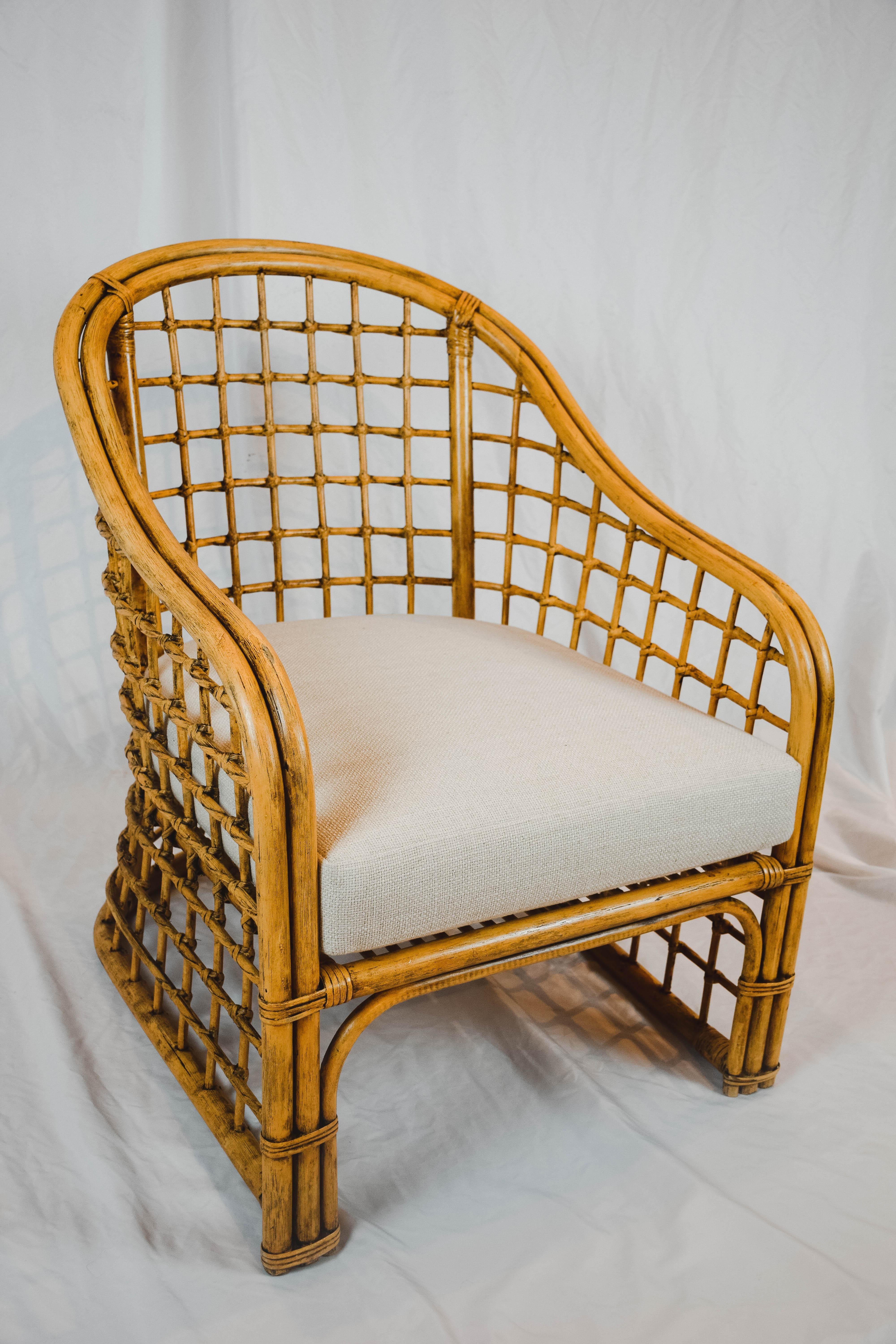 This vintage rattan lounge chair is designed for comfort and is graceful in styling. The new cushion is upholstered in a linen/poly blend that accents the contour of the chair. Strong and sturdy, this chair will add style to any home decor.