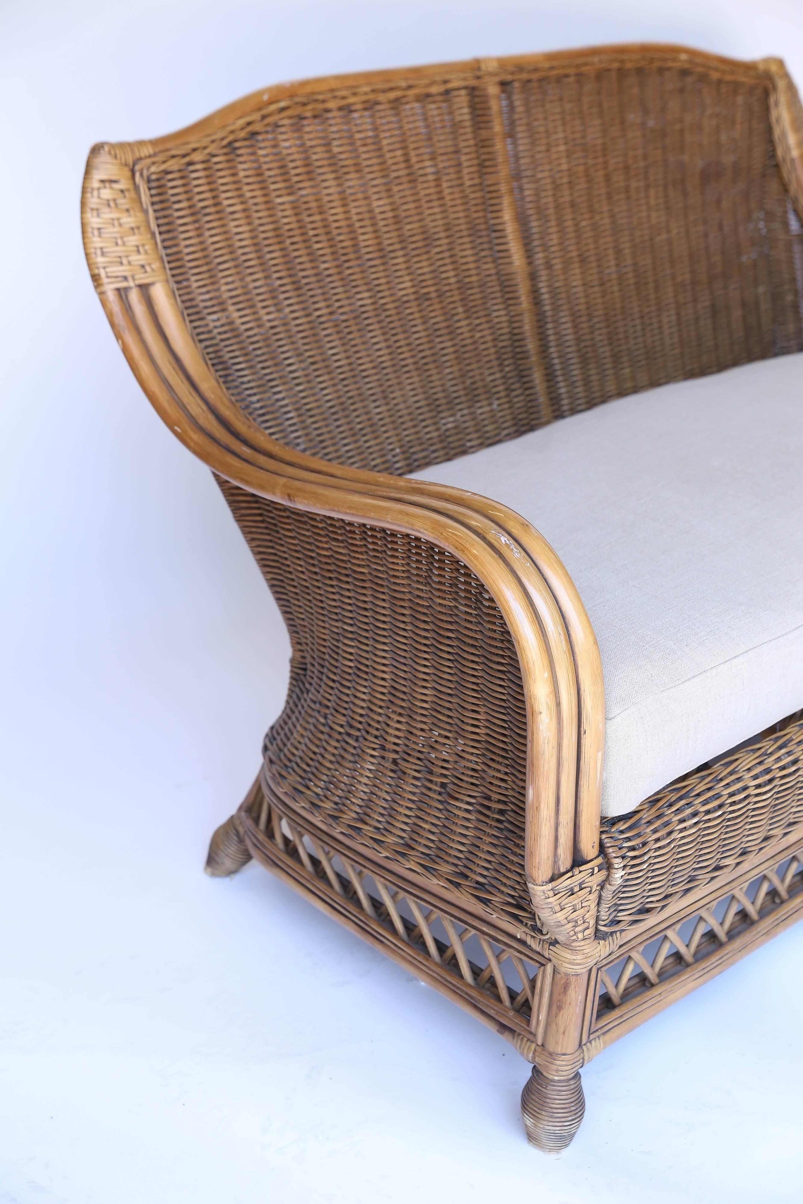 This vintage rattan settee is as comfortable as it is stylish. Placed in any setting, this is sure to make a memorable statement.