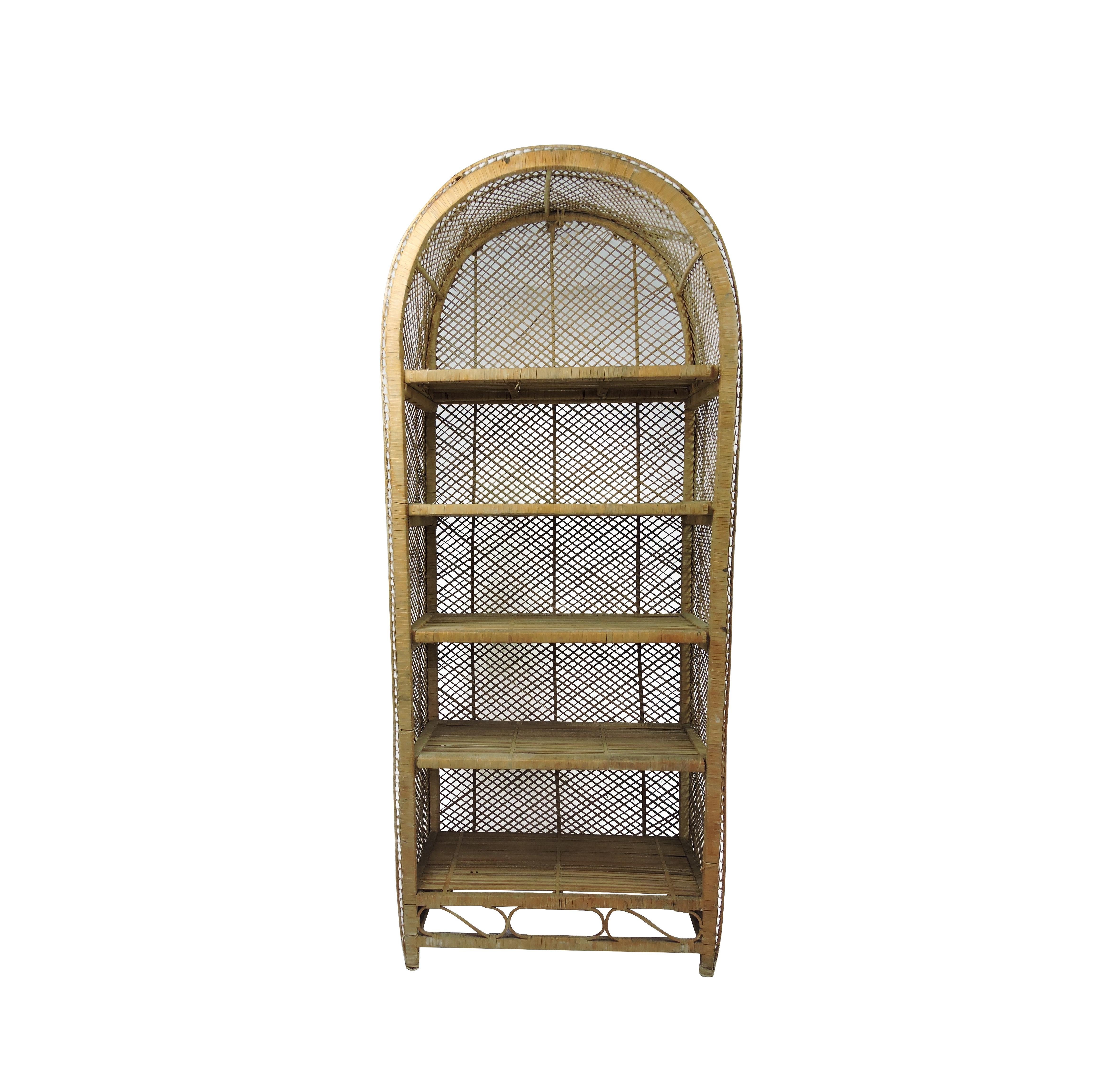 A vintage rattan bookshelf/ Bohemian bookcase with arched top and wrapped edges. The bookcase features four shelves.