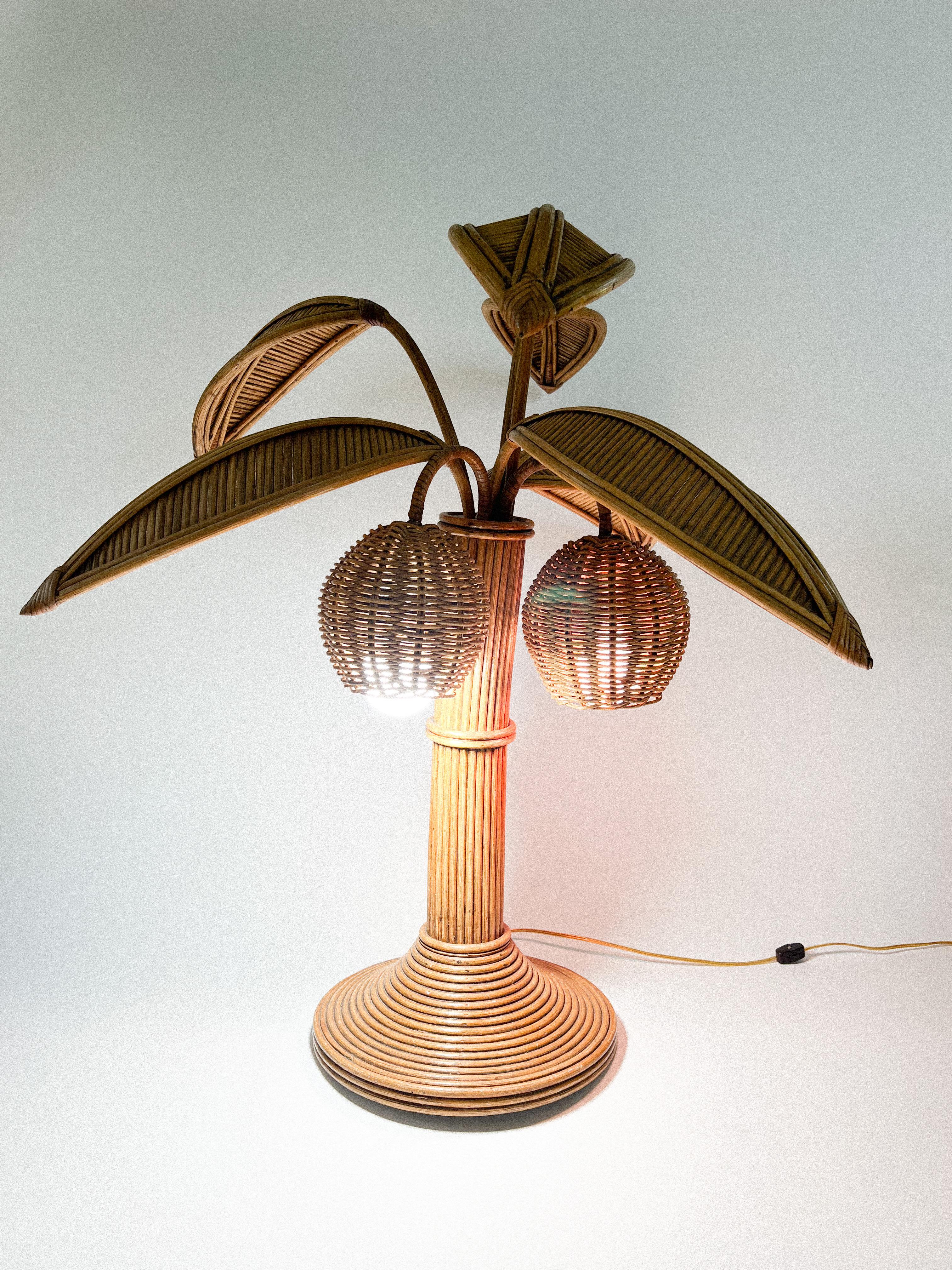 Bamboo palm tree table lamp in the style of Mario Lopez Torres with two coconut lights under the leaves. 

Lights not included.