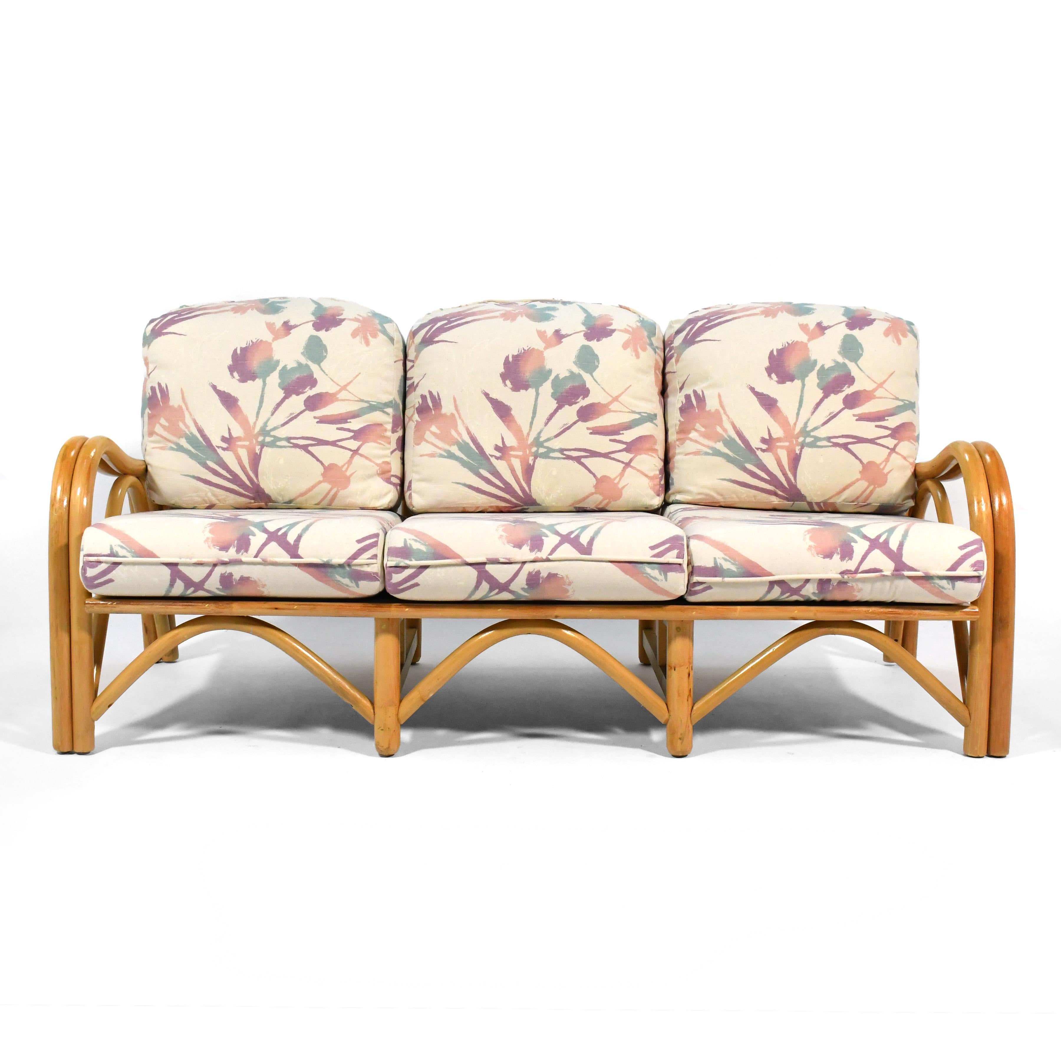 This great three seat rattan sofa is perfect for a mid-century pad or tropical Tiki room. It's incredibly well built and in great original condition.

It has a nice seat depth and pitch, making it very comfortable. The wave-like profile of the