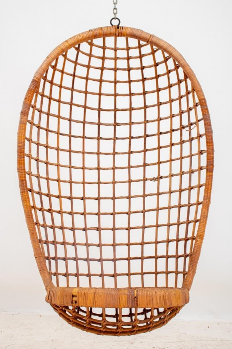 Vintage rattan or wicker hanging egg chair, open-weave design with closed-weave seat, with steel chain to be hang to ceiling, wear to rattan, circa 1970s. Without chain: 49