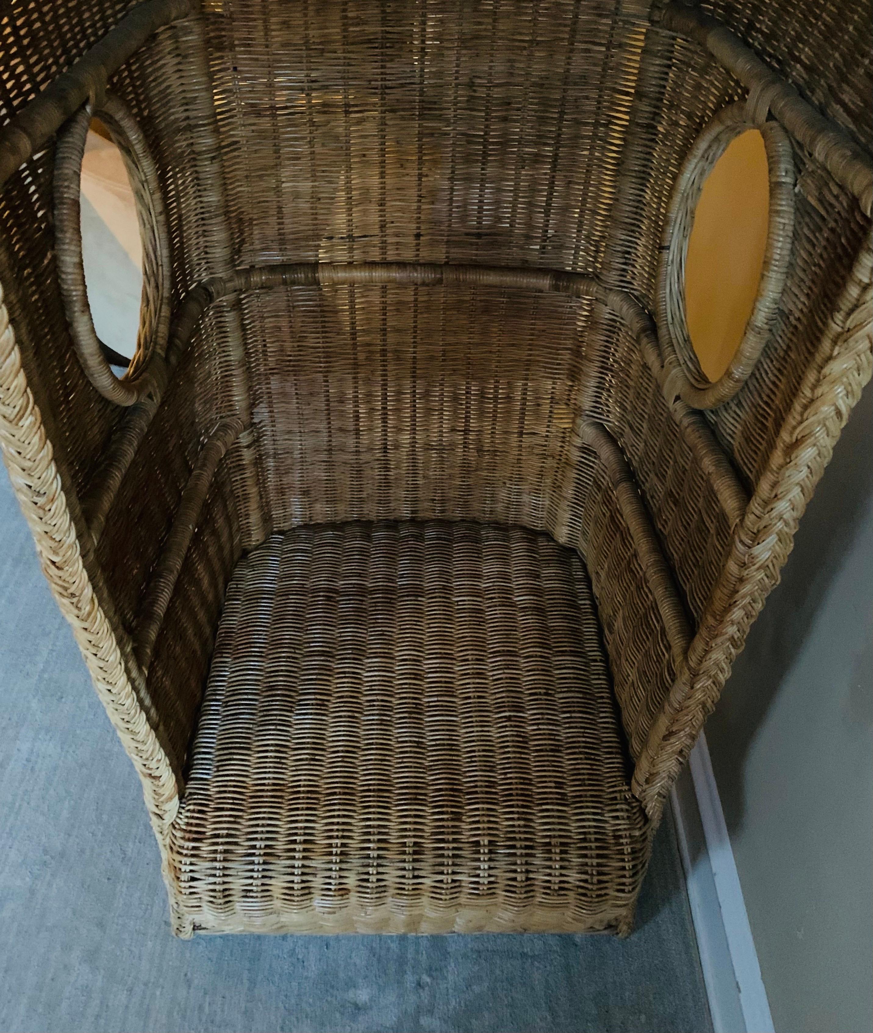 Wonderfully large statement chair with a large canopy hood, replete with port holes.

This piece is in strong complete condition with no holes or issues with the rattan. 

The original natural hue of the rattan remains and is not stained or