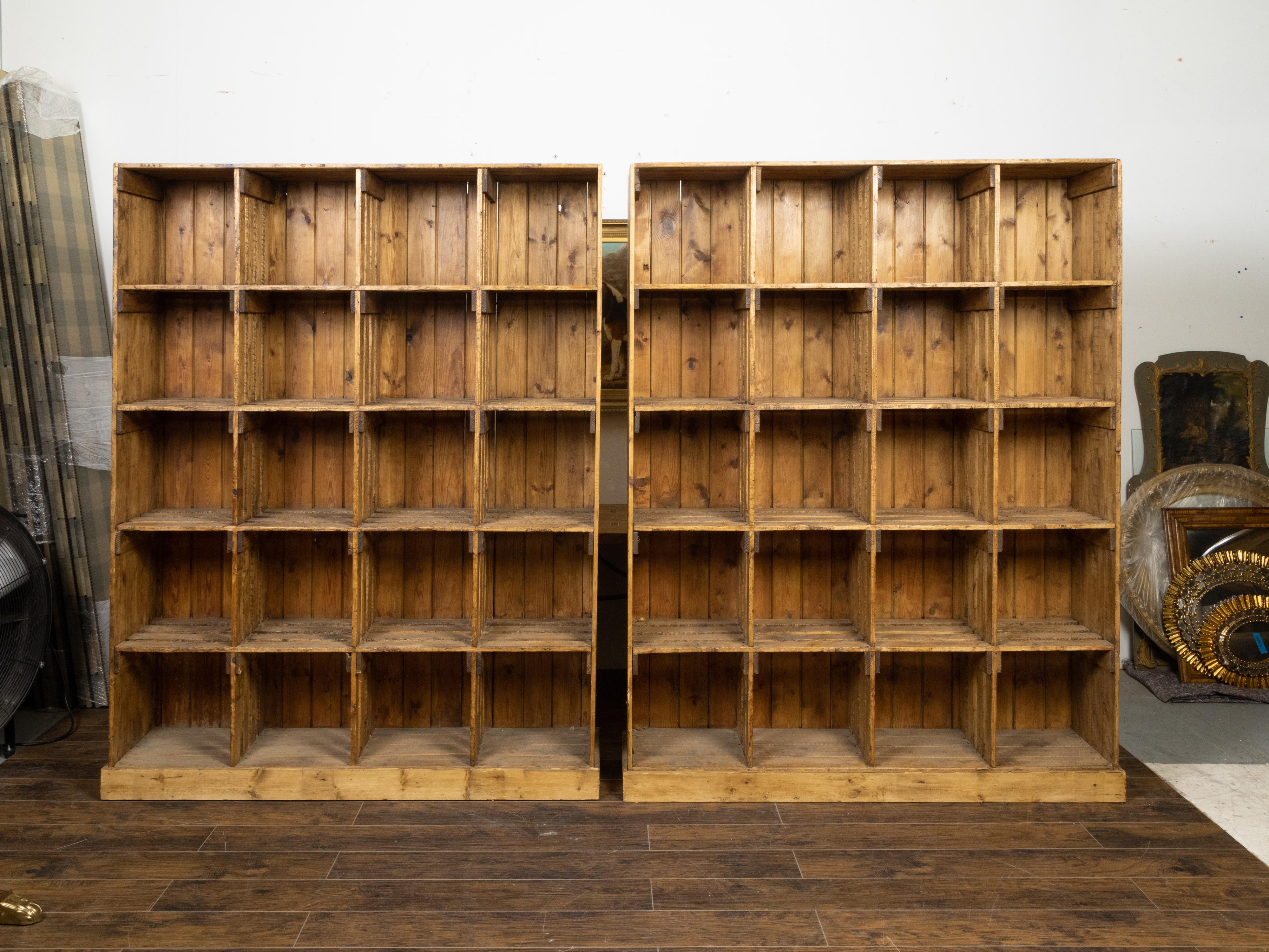Two vintage English raw wood pine display or storage cabinets from the mid 20th century, with twenty cubby holes each and nicely weathered appearance. They are priced and sold individually $5,500 each. Created in England during the Midcentury