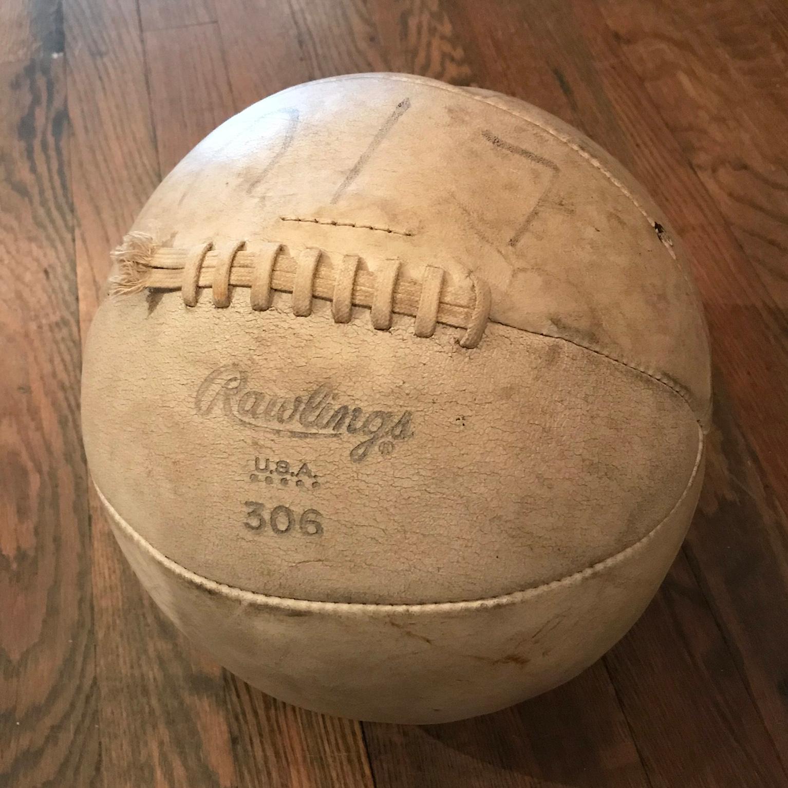 Vintage medicine ball by Rawlings #306 for upper body strength training features a white leather hide with it's original well-worn patina.