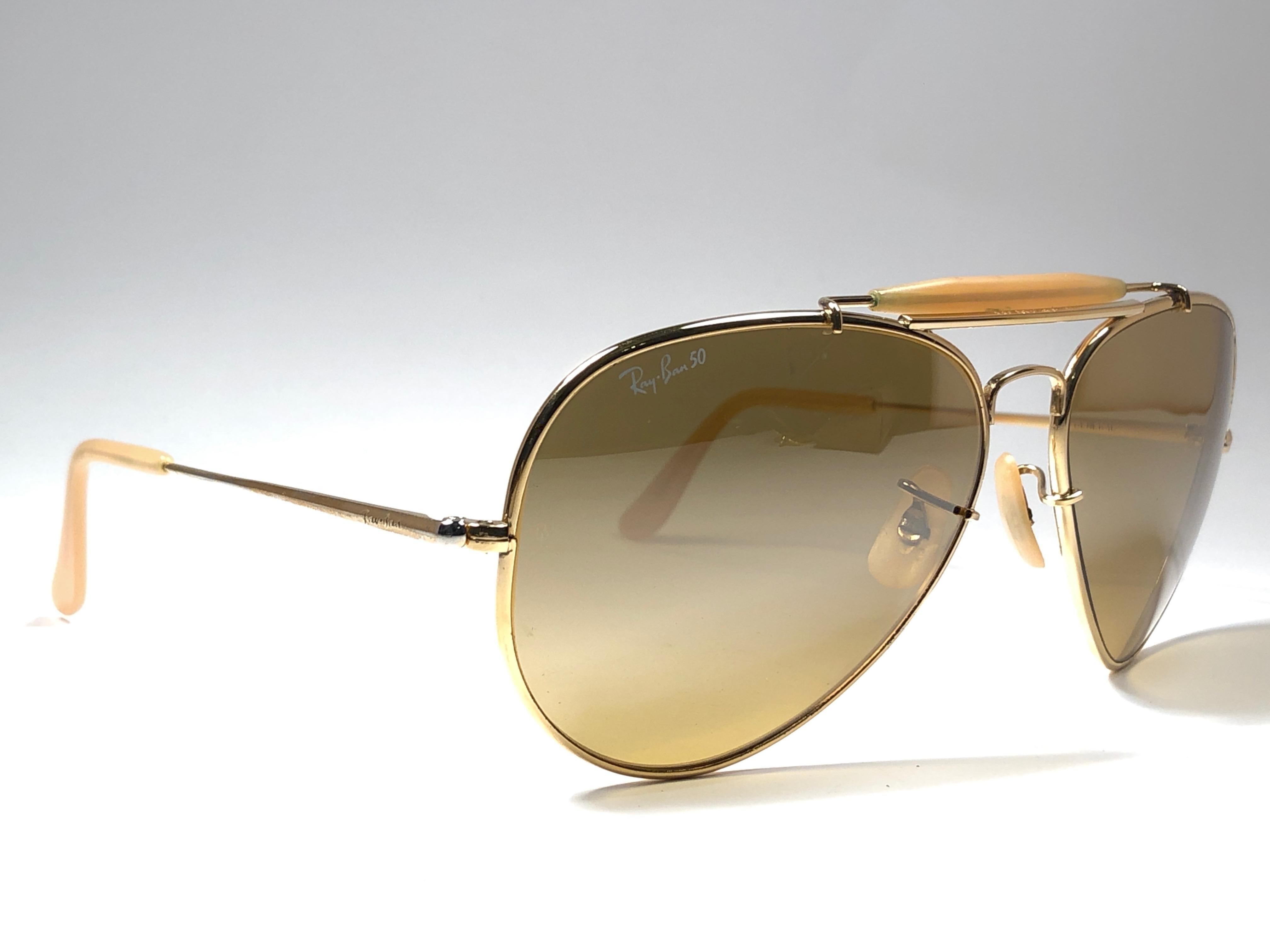 Mint 50th Anniversary Edition 1937-1987 Ray Ban The General Gold Bravura frame with the extra strong temples. 
RB 50 Ambermatic mirror lenses. Ray Ban 50 written on the right lens. B&L Ray Ban Usa. Under the bridge 62 [] 14. Comes with original