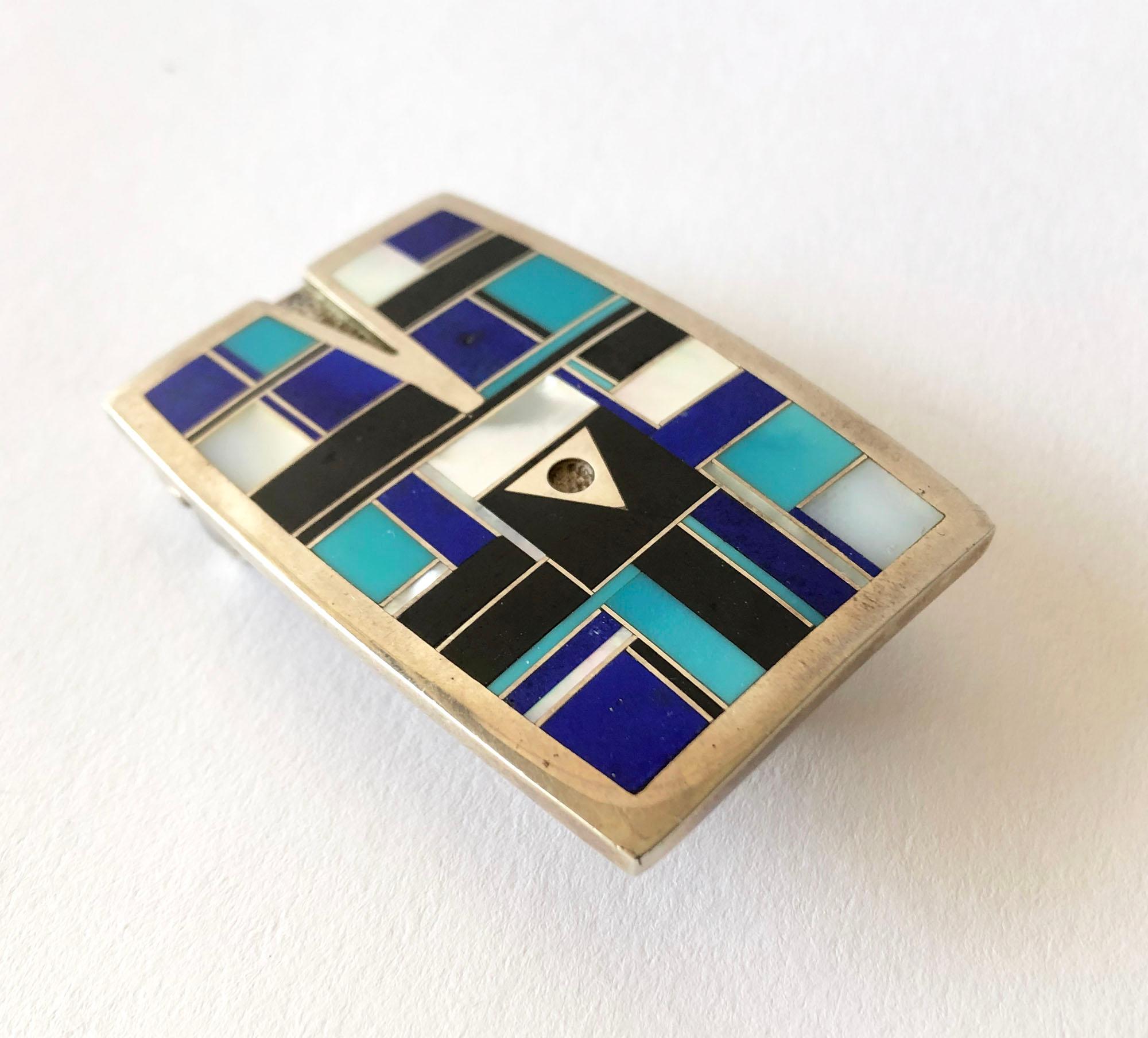 Vintage inlaid lapis lazuli, mother of pearl and sleeping beauty turquoise belt buckle with arrow design within, created by Navajo jeweler Ray Tracey.  Buckle measures 2.25