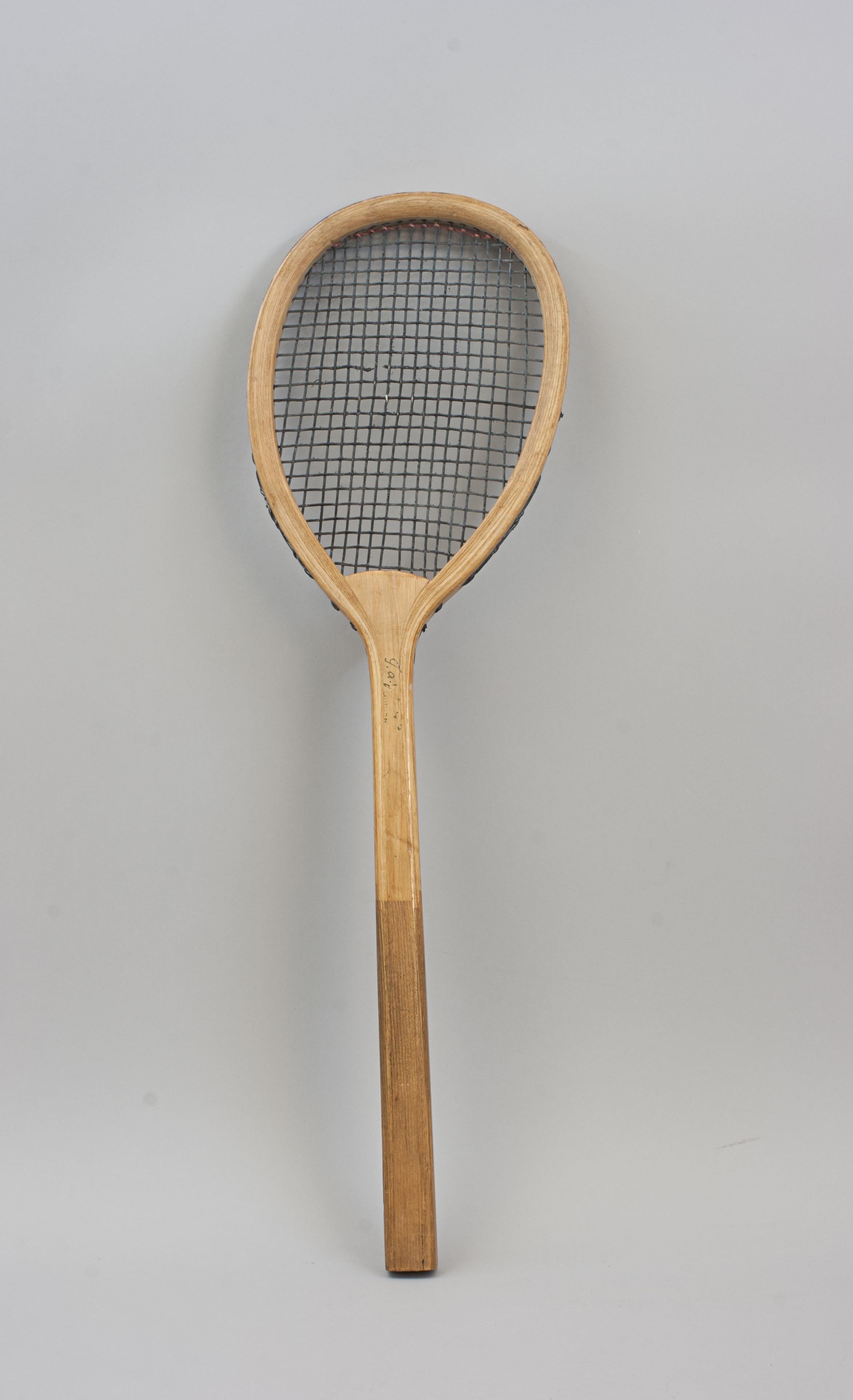 Vintage Harris Real Tennis Racket.
A good real tennis racket with original black stringing (one broken string) made by T.A.J. Harris, London. The ash frame in good condition with the characteristic offset or tilt-top shape. There is the remains of a