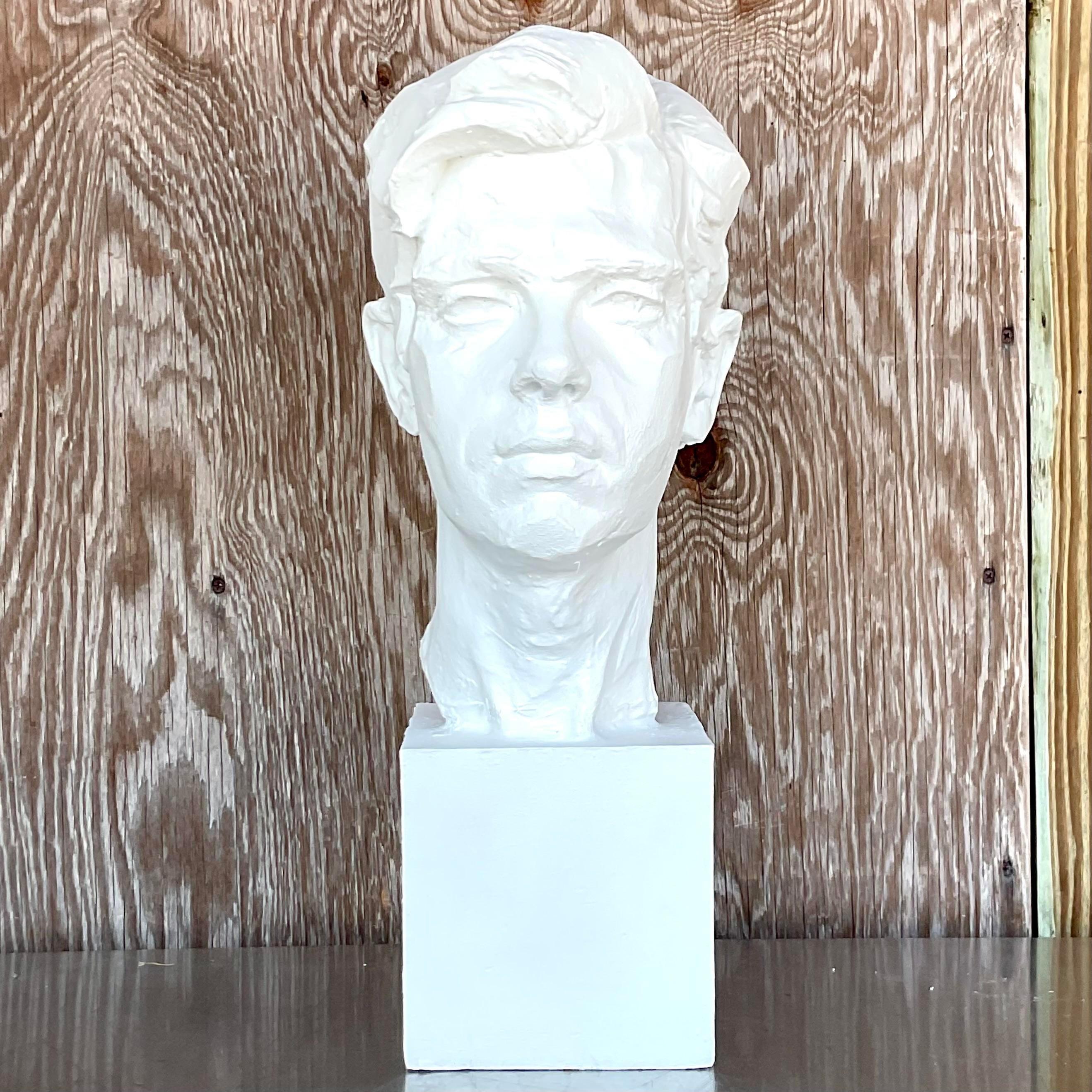 A stunning vintage Boho sculpture of man. A chic plaster composition resting on a wood block plinth. A chic plaster white finish. Acquired from a Palm Beach estate.