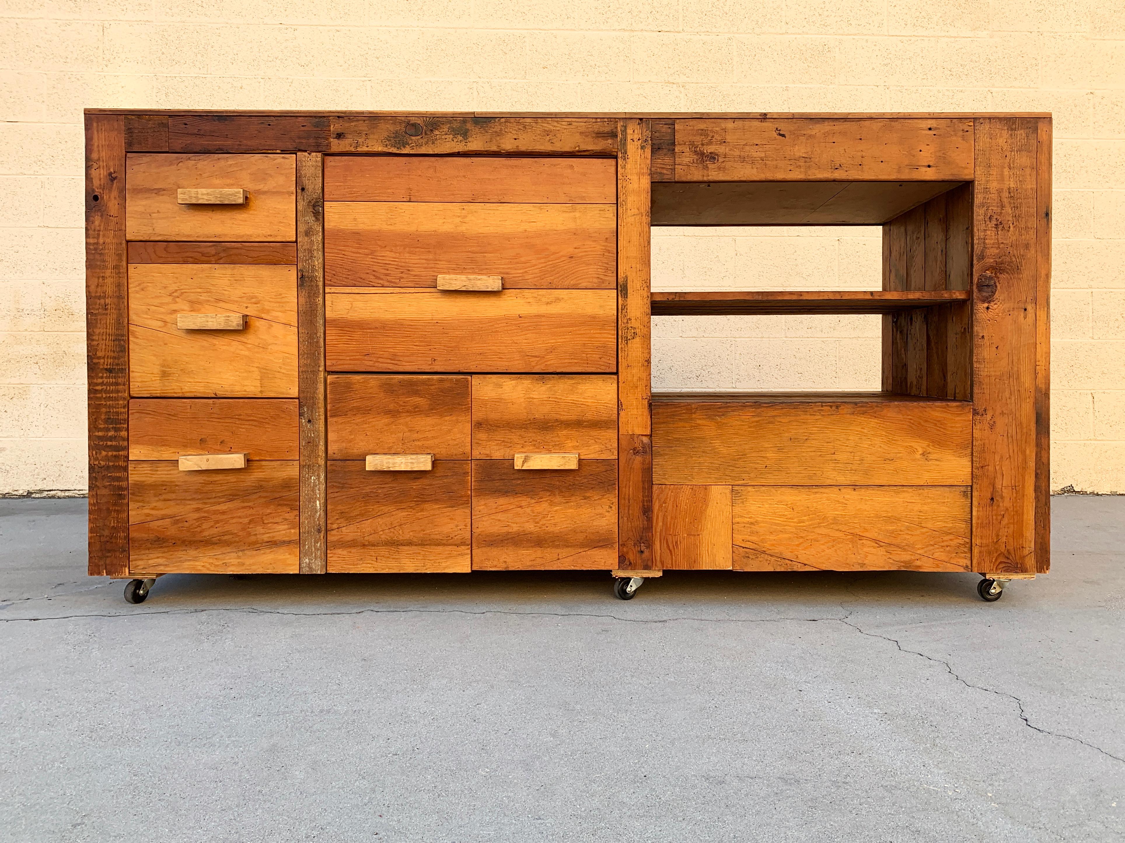 Massive sales counter, work station or retail display, custom made with reclaimed barn wood. This beautiful, one of a kind piece features 6 drawers with wood handles, two shelves and rolls on casters. Great rustic styling; great patina.

Excellent