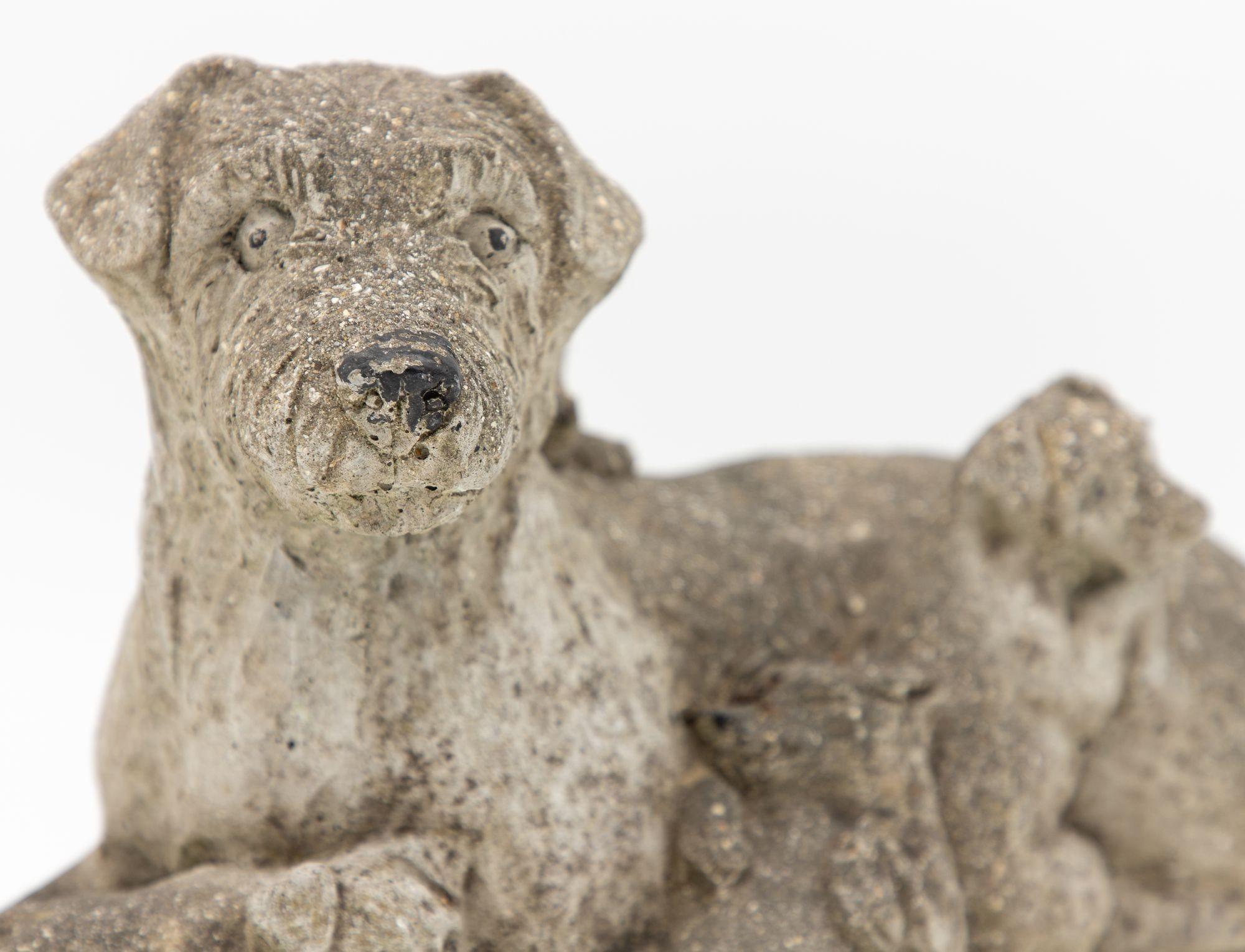 This vintage reconstituted stone garden ornament, hailing from mid-20th century England, is a charming and heartwarming addition to any garden-inspired space. Crafted with meticulous attention to detail, it depicts a proud and watchful dog