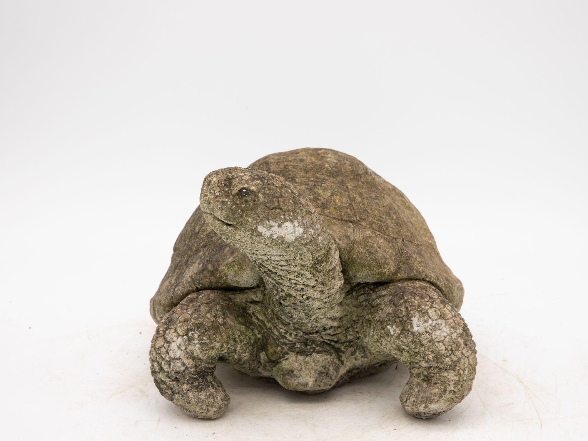 This mid-20th century vintage concrete garden ornament, originating from the United Kingdom, takes the form of a captivating tortoise or turtle. Its meticulous craftsmanship is evident in the intricate detailing of the tortoise shell, which