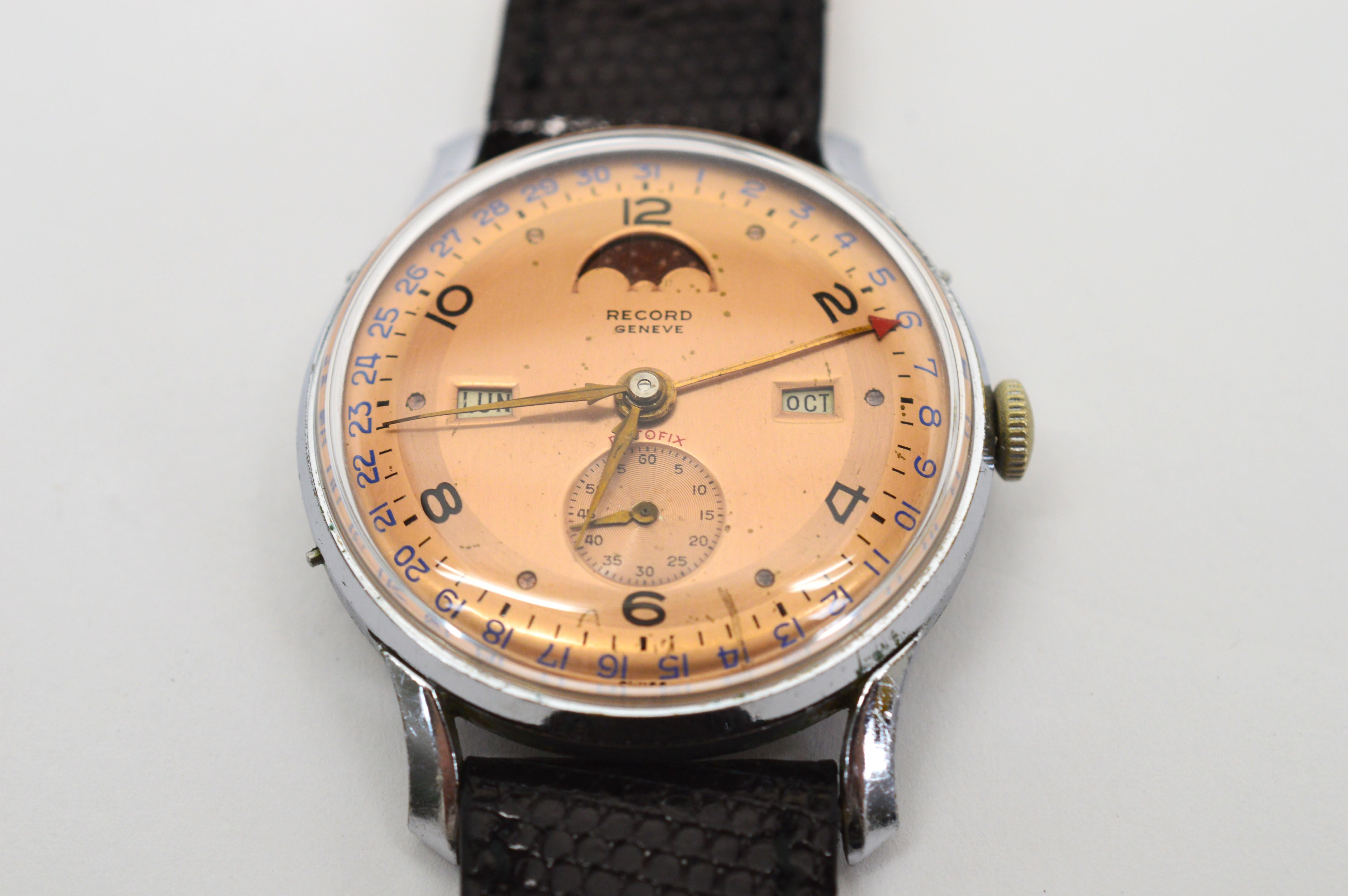 Fabulous mid-century Record Watch Company Datafix Triple Date Moon Phase Cal 107C Reference 257. Steel Men's watch in Acier Case #13321, size 35mm, with an attractive copper color face. Arabic numerals indicate time on even numbers.  Features