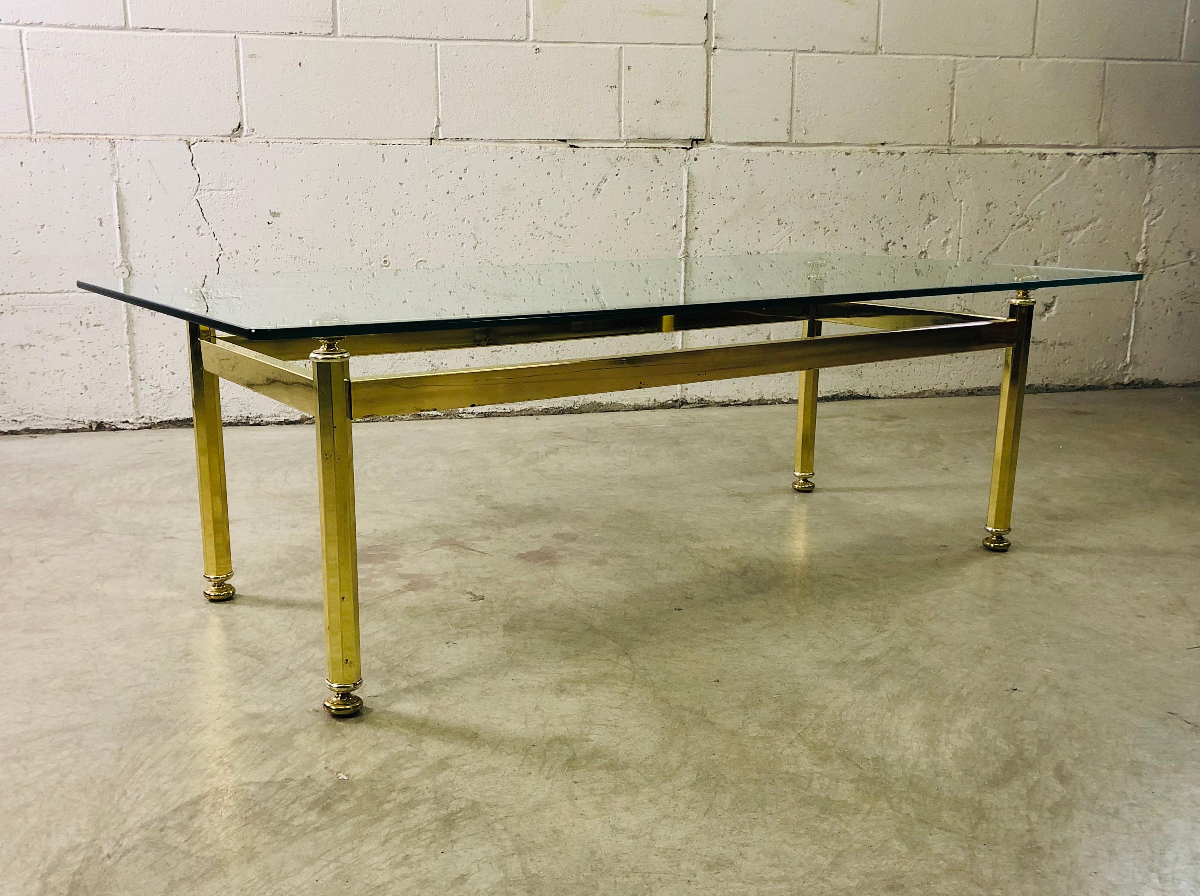 Vintage 1970s rectangular brass and glass top coffee table. Minimal wear to the glass and the table is sturdy. No marks.