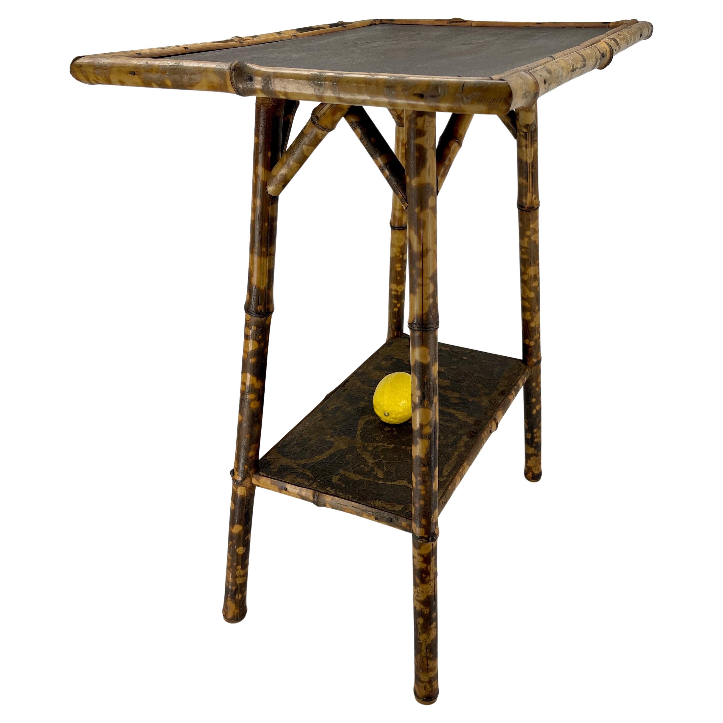 English Two Tier Rectangular Burnt Bamboo Side Table, From The Early 1930's 

Fabulous vintage burnt bamboo side table. This tiered side table or accent table is made of a combination of a wood painted top with burnt bamboo legs. The top is