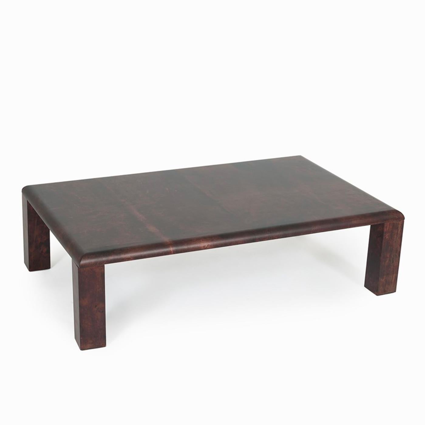 Striking in its simplicity, this one-of-a-kind coffee table is an original piece from Tura's collection and there is only one available. The low frame with a rectangular silhouette, whose sharp lines are softened by rounded edges and corners, is