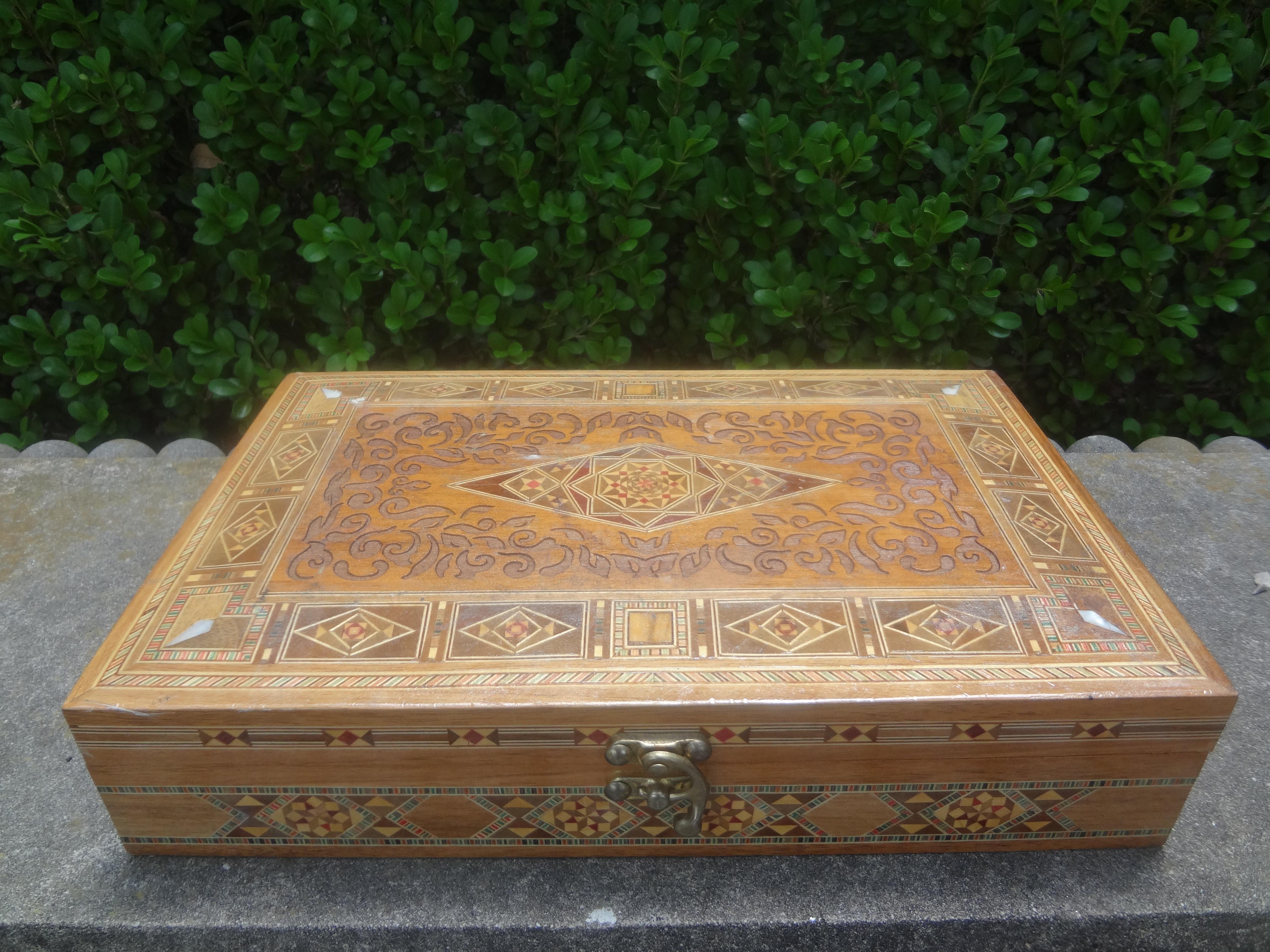 Vintage rectangular Moroccan inlaid decorative box. This unusual Moroccan or Middle Eastern Arabesque box of mixed inlaid woods in a mosaic pattern is the perfect coffee table accessory.