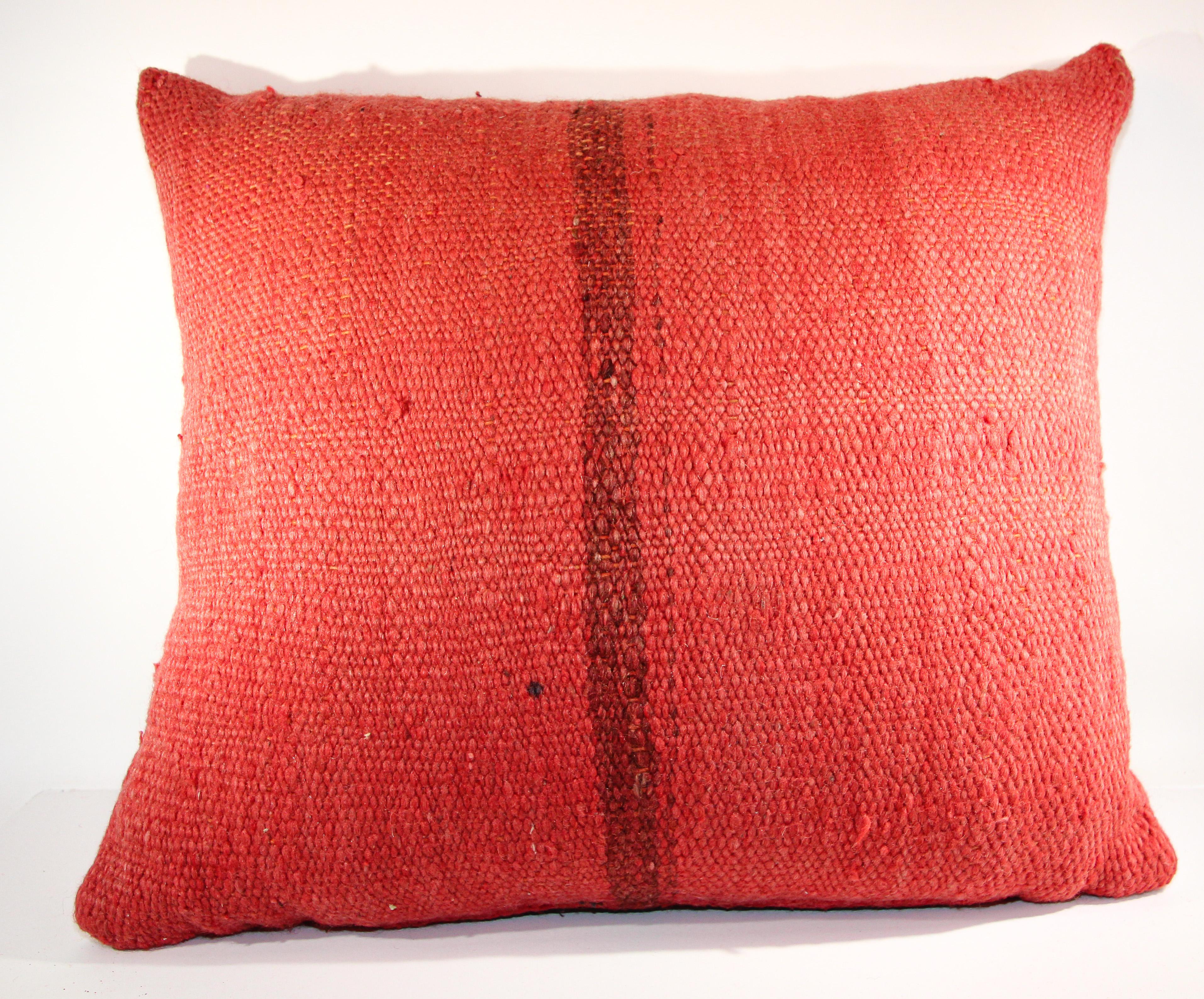 Vintage Moroccan Berber red pillow cut from an old handwoven Moroccan tribal flat-weave Kilim tribal rug.
Great handcrafted textile with red earth tone color handwoven by the Berber women from the Atlas Mountains of Morocco. 
Circa 1960-70.
   
