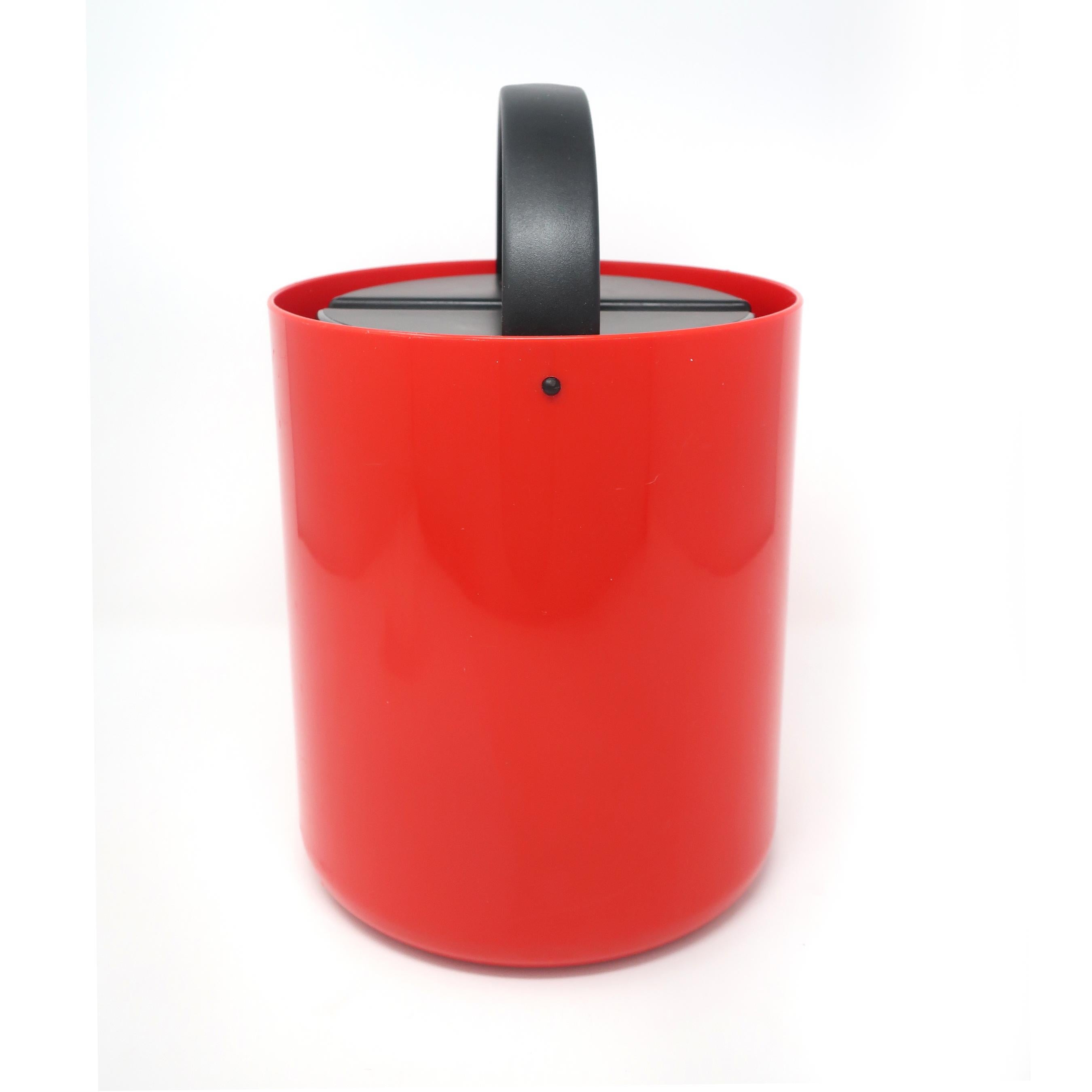A vintage red and black ice bucket from the 1980s with a set of four black plastic drink stirrers designed by Carsten Jorgensen for Bodum. Red bucket with black liner, black lid, and black handle that stows away alongside the lid.

In very good