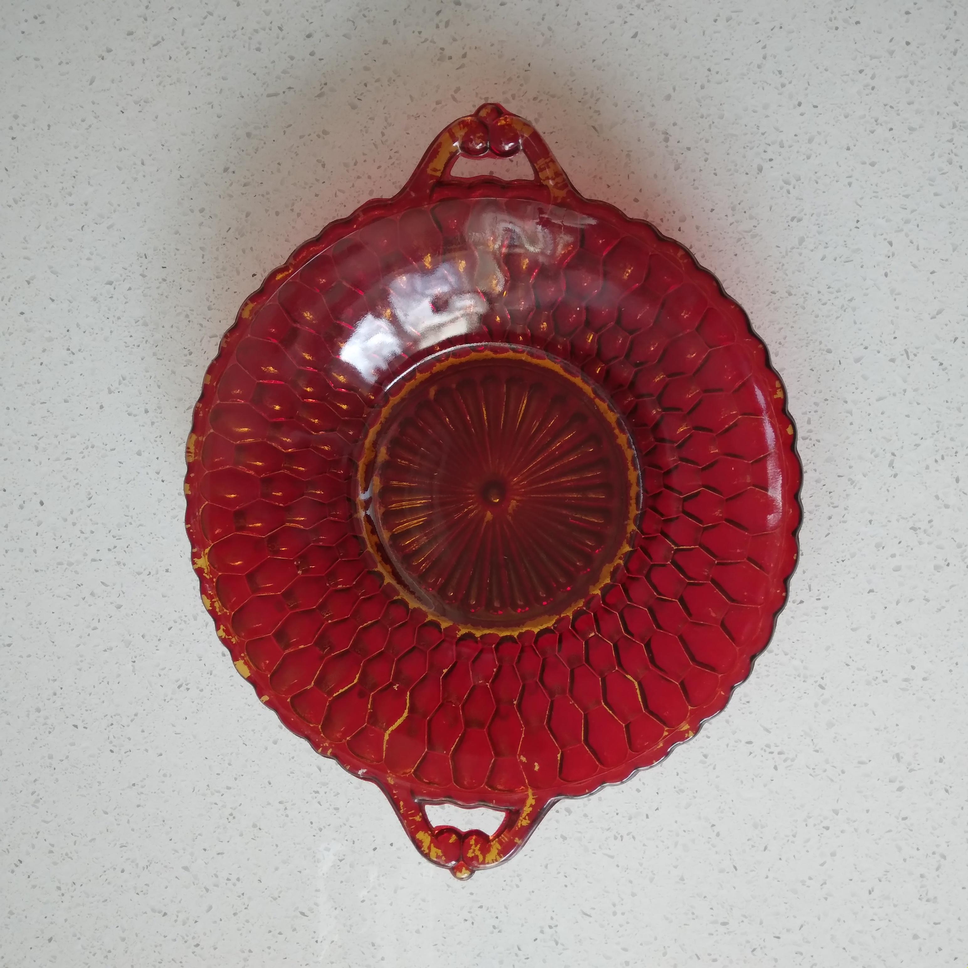 Gorgeous in red and gold, this vintage dish features an lovely honeycomb design and adorable handles. Some of the red has begun to peel off of the underside, but it just allows more of the gold to show through from the top. Great for decorative use!