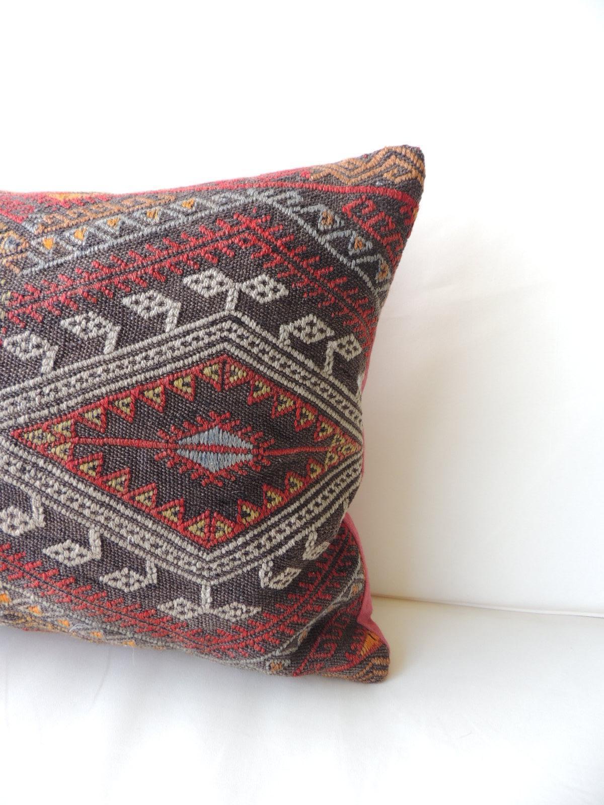 Vintage red and orange woven Kilim bolster decorative pillow
with pinkish linen backing.
Decorative pillow handcrafted and designed in the USA. Closure by stitch (no zipper closure) with custom made pillow insert.
In shades of red, grey, black,