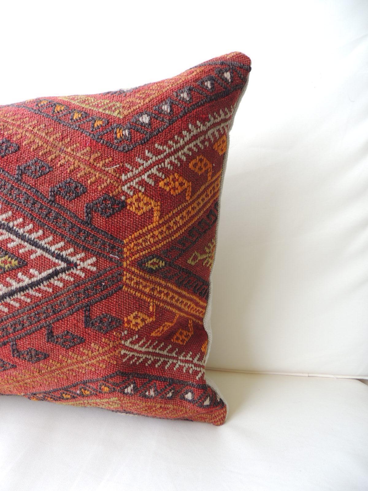 Vintage red and orange woven Kilim bolster decorative pillow
with natural linen backing.
Decorative pillow handcrafted and designed in the USA. Closure by stitch (no zipper closure) with custom made pillow insert.
In shades of red, grey, black,