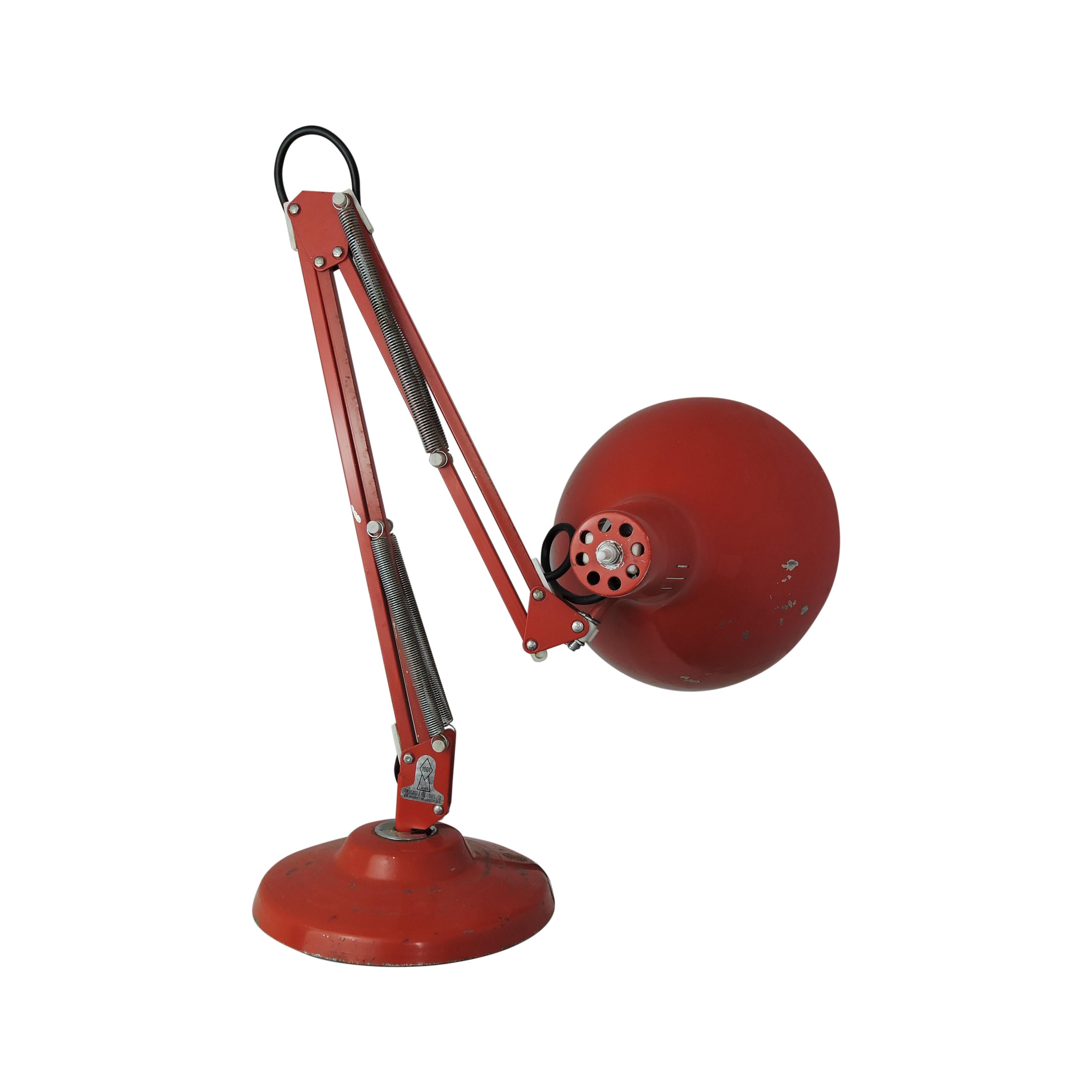This red balanced arm desk lamp was made by 1001 Lamps, London. The label on the bottom of the arm reads 1001 One Thousand and One Lamps Ltd, 108 Bromley Road, London SE6.