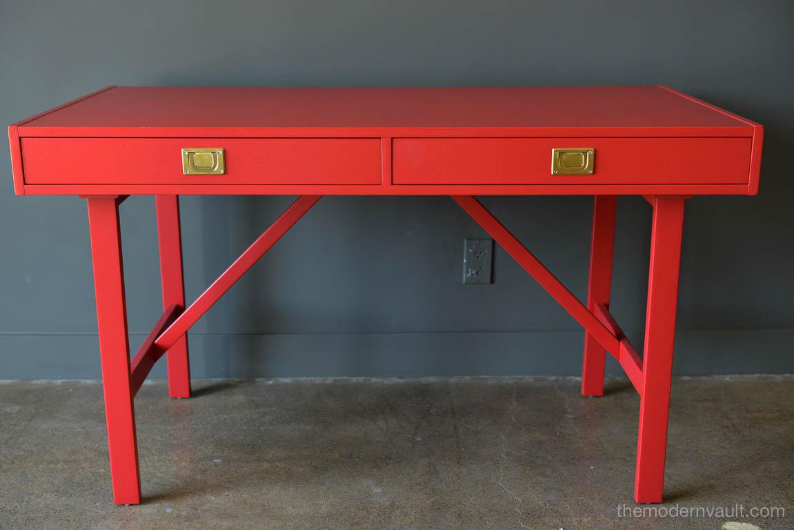 Vintage Campaign desk in red with original brass hardware, circa 1970. Professionally restored in perfect condition. Brass detailing and an open return (back) side for additional storage.

Measures 49